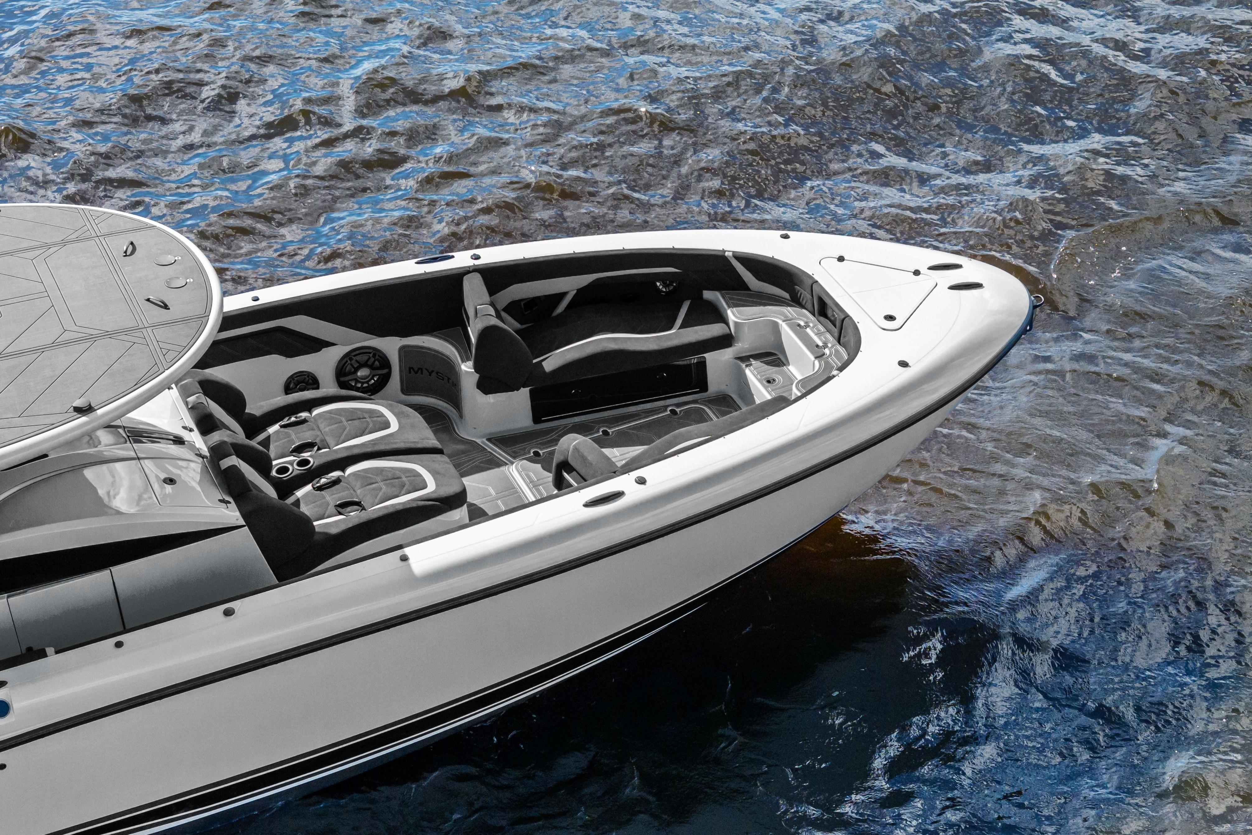 2027 Mystic Powerboats M4200 on water, showcasing sleek design and luxurious seating.
