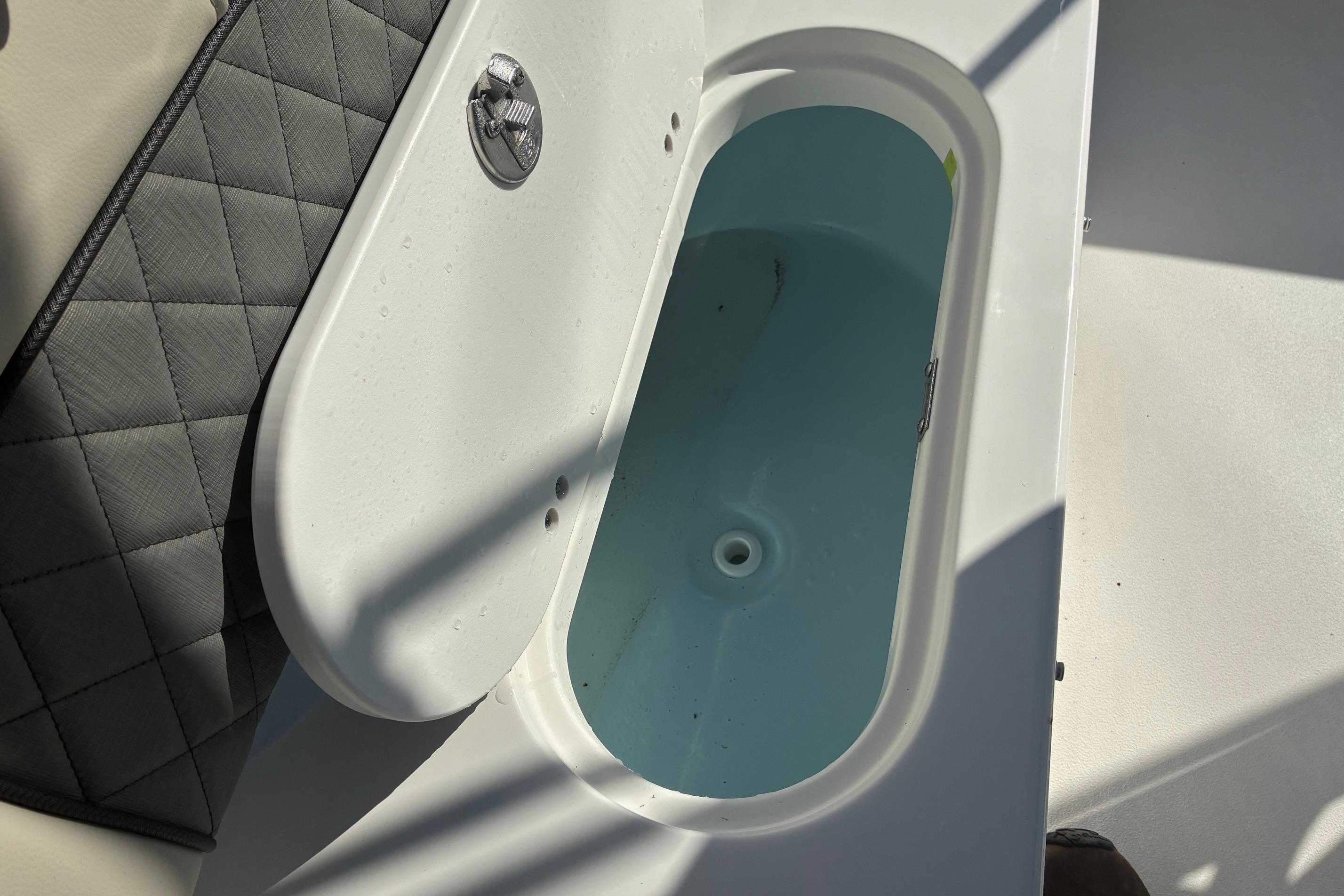 Open storage compartment on 2026 Key West 189 FS boat, showing interior details.