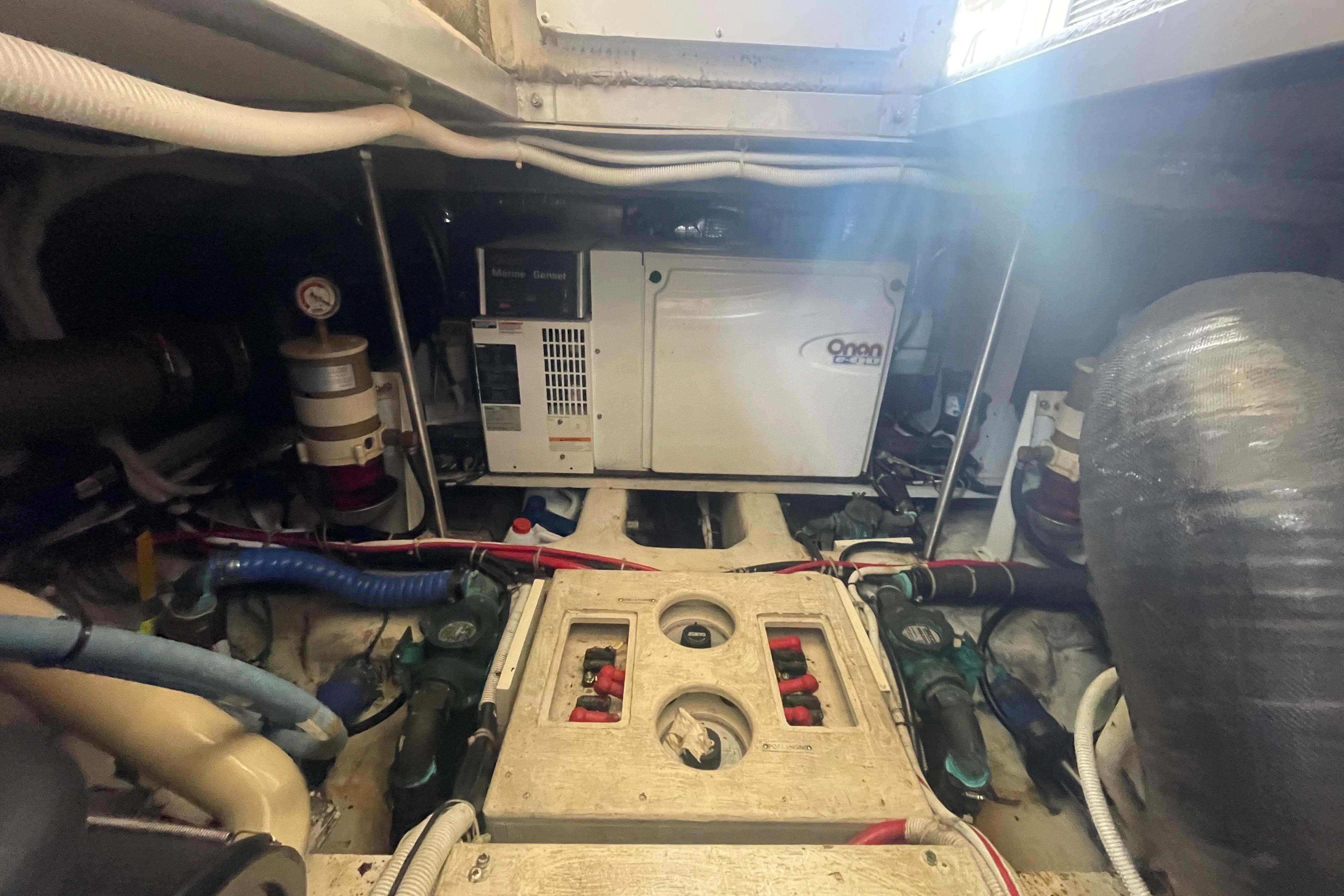 Engine room of a 2002 Carver 410 Sport Sedan with visible generator and components.