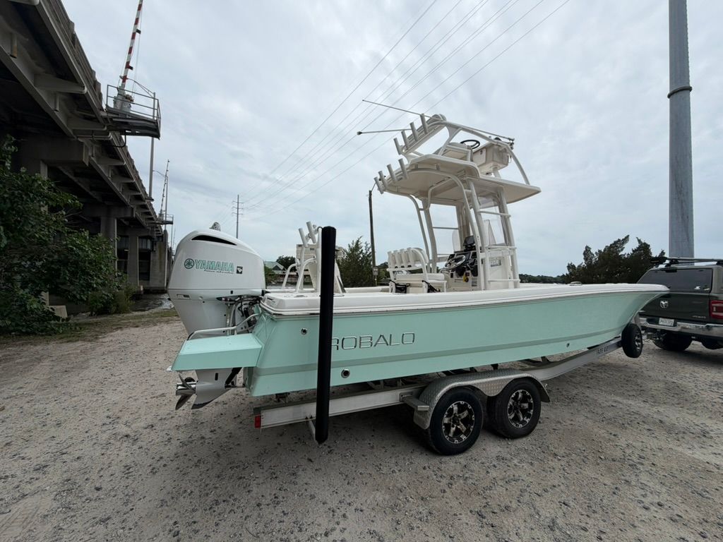 2018 Robalo 246 Cayman SD boat on trailer under bridge.