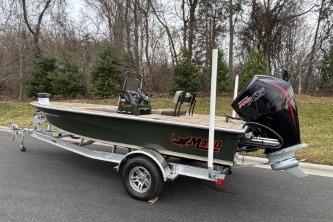 2025 Mako 18 Pro Skiff Backwater Edition on trailer, parked outdoors.