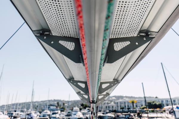 Underneath view of Vision 444 sailboat mast, 2026 model, with marina background.