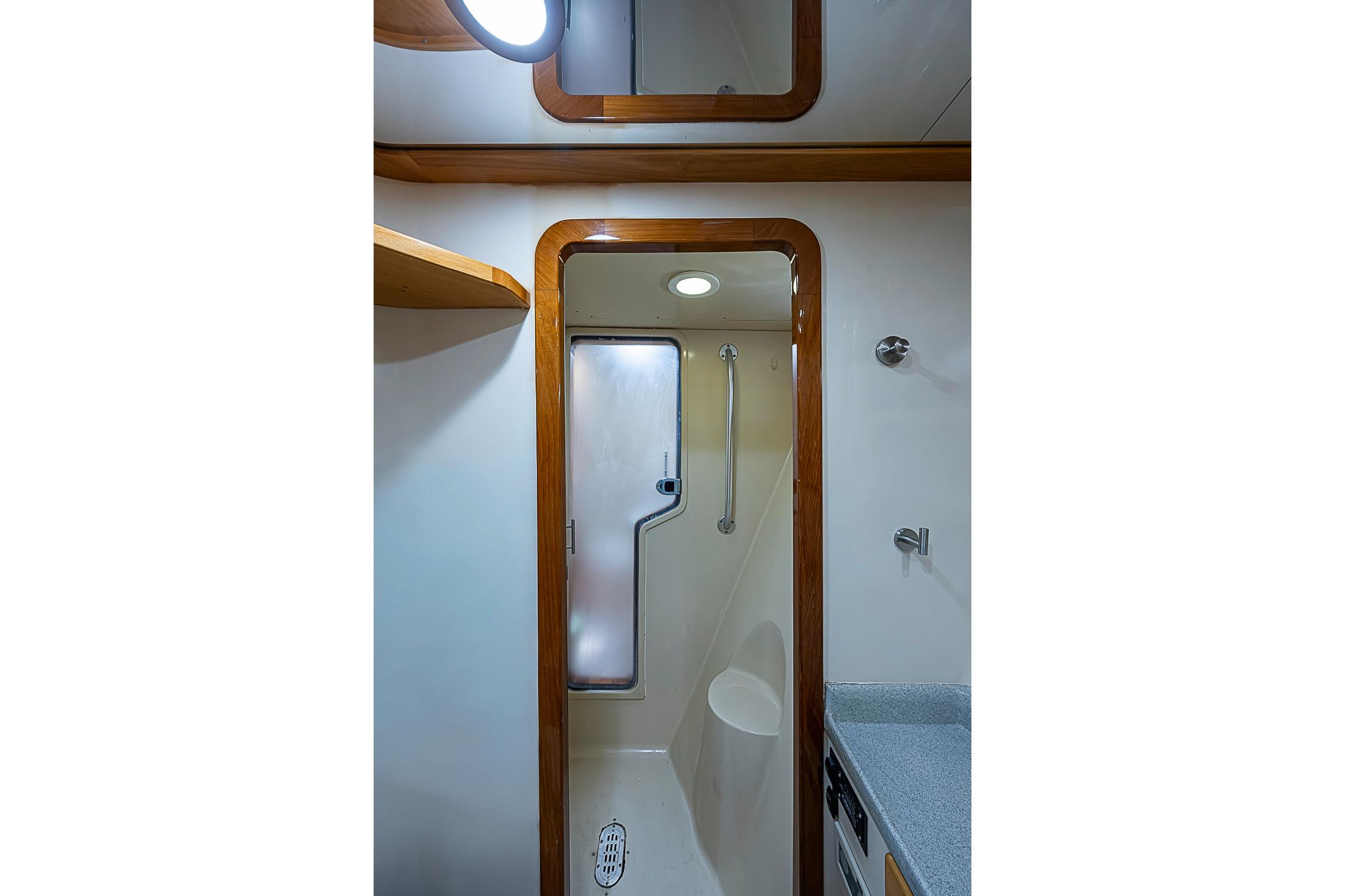 Bathroom interior of 2003 Magna Marine Nova Scotia 47 yacht, featuring shower and wooden trim.