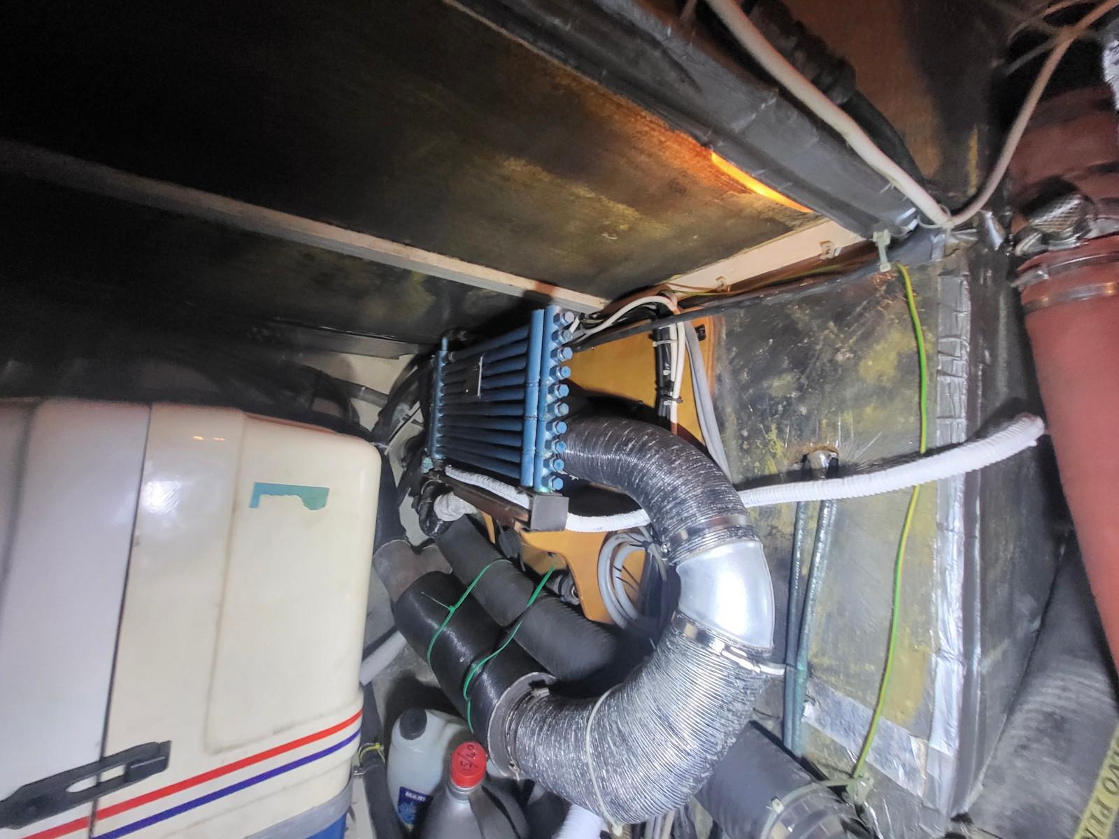 Engine room of a 1991 Najad 440 yacht, featuring mechanical components and wiring.