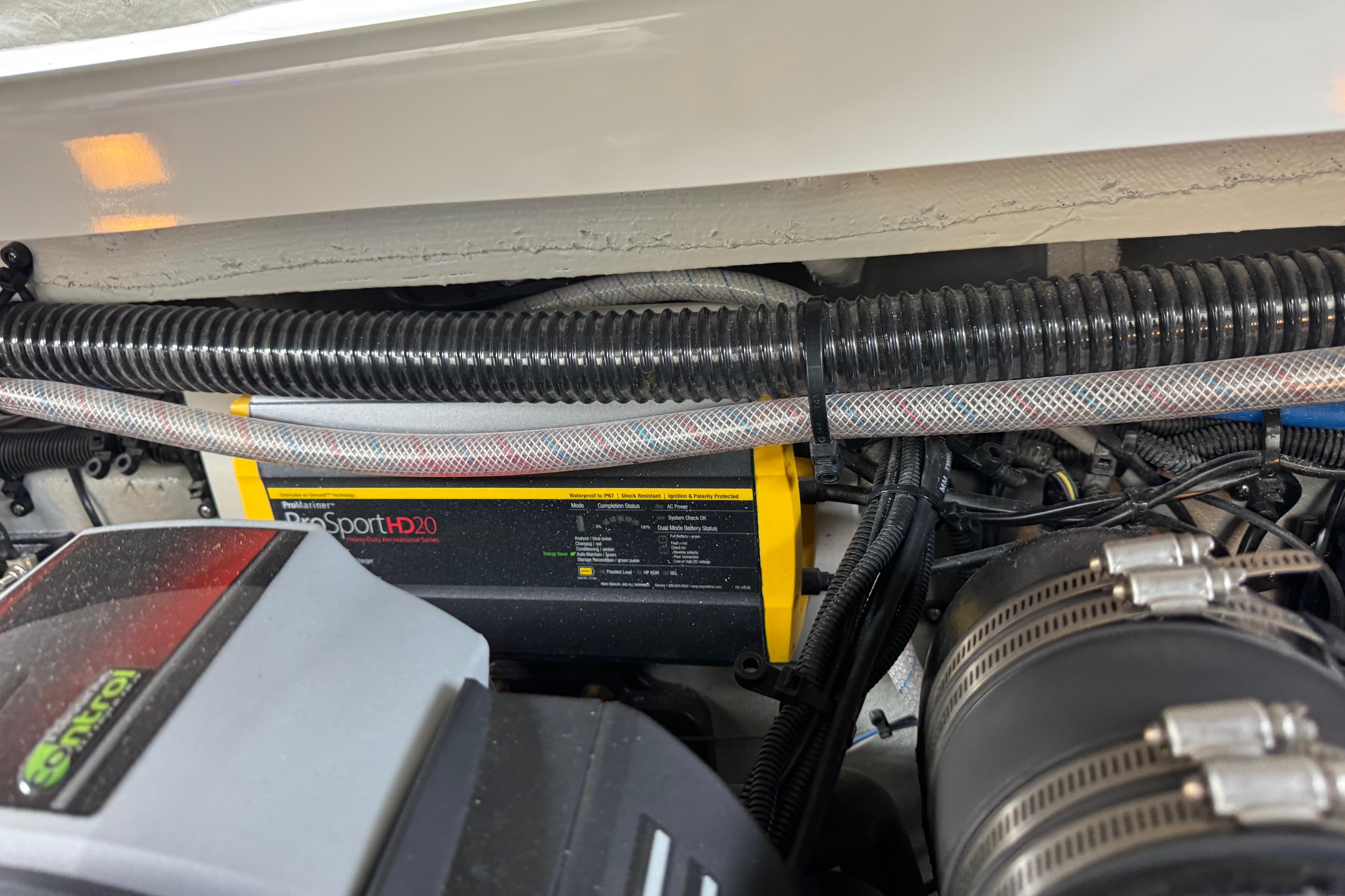 Engine compartment of 2022 Crownline 265 SS with ProSport HD20 charger visible.