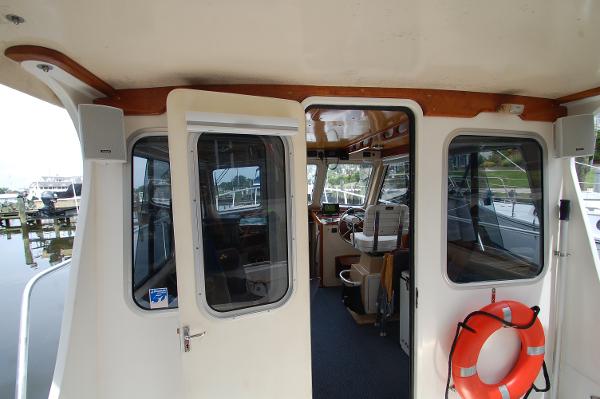 Interior view of a 2005 Fox Island Thirty - Sedan Cruiser with open door and life ring.