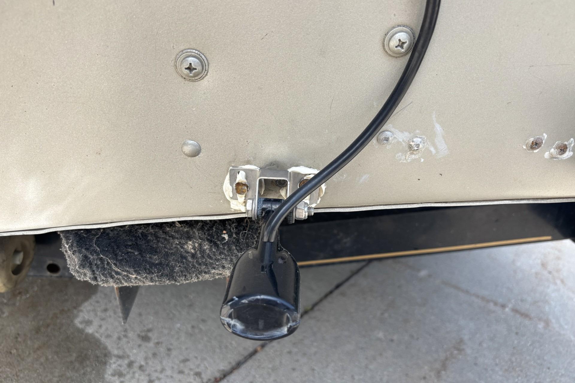 Close-up of a 1999 Tracker Targa 18 boat's transducer installation.