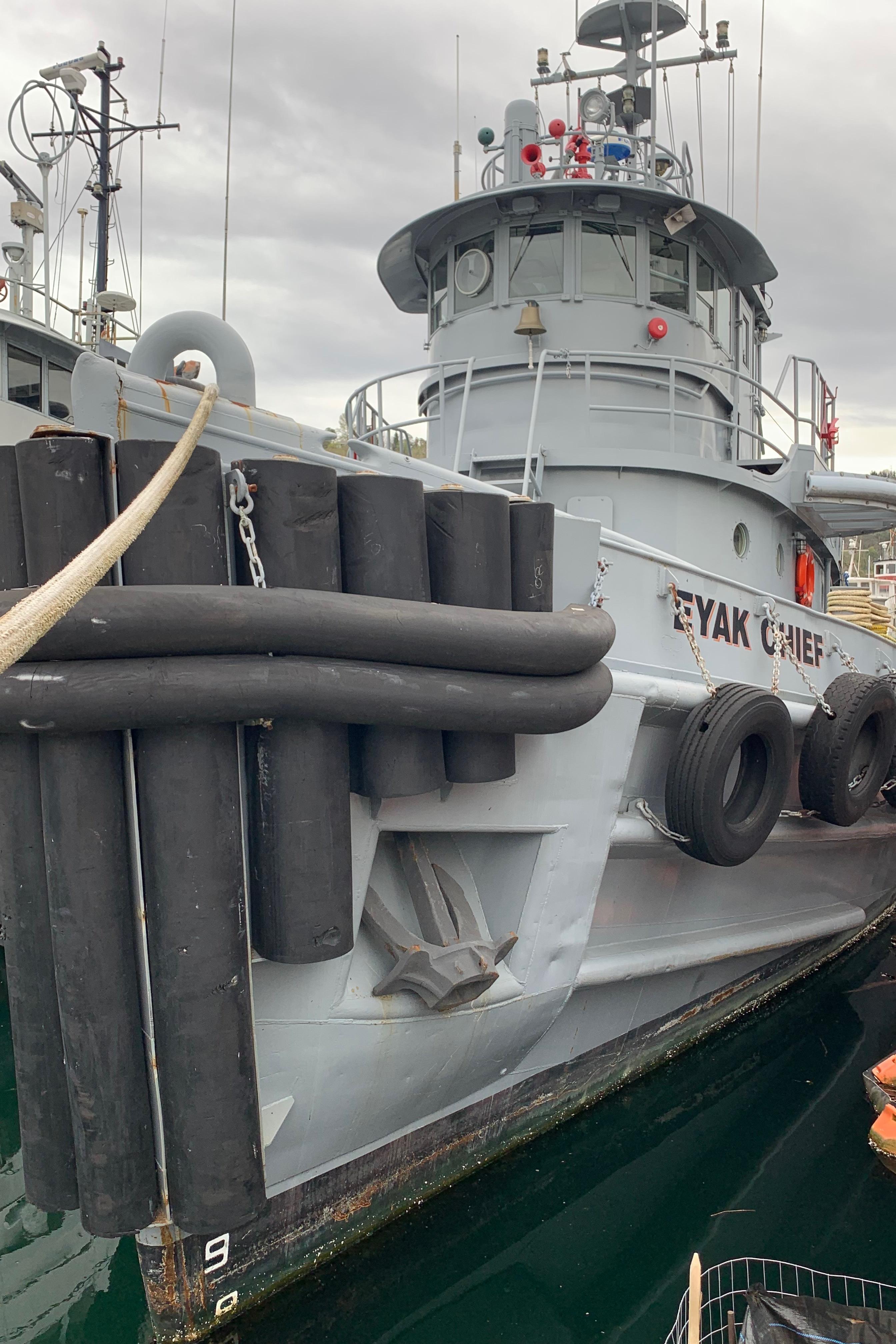 1955 L-T 100 Steel Army Tugboat docked, featuring robust design and fendering.