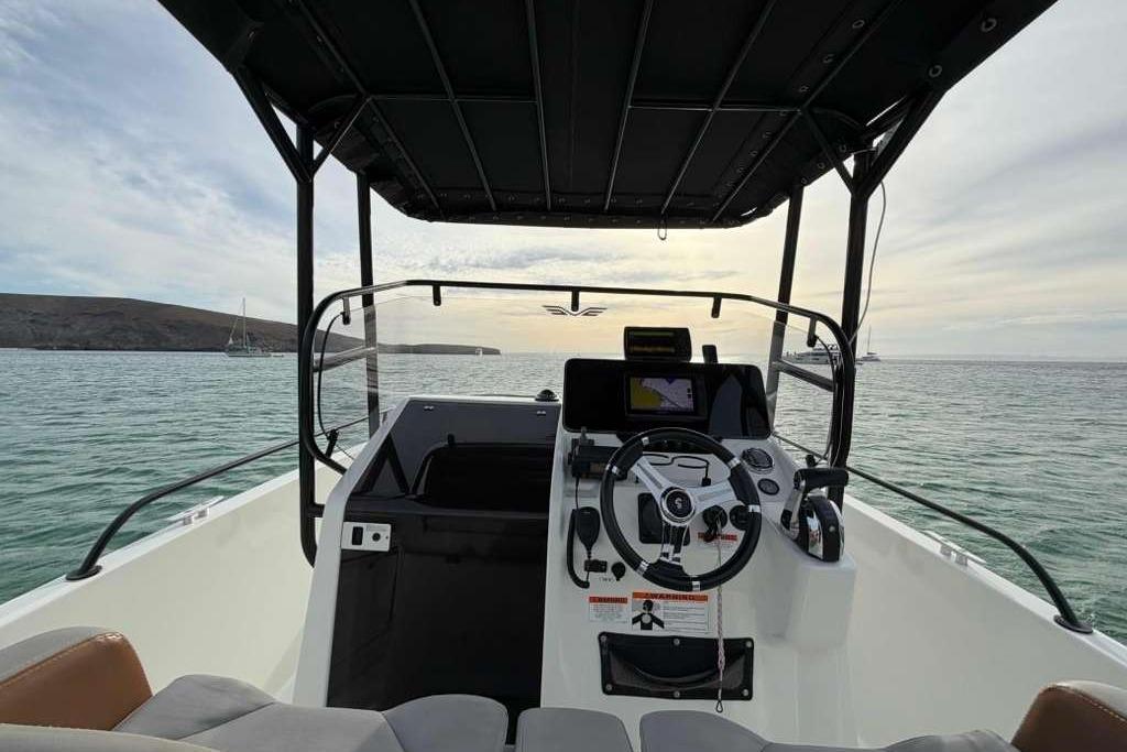 Cockpit view of 2019 Lagoon 630 MY yacht on calm waters at sunset.