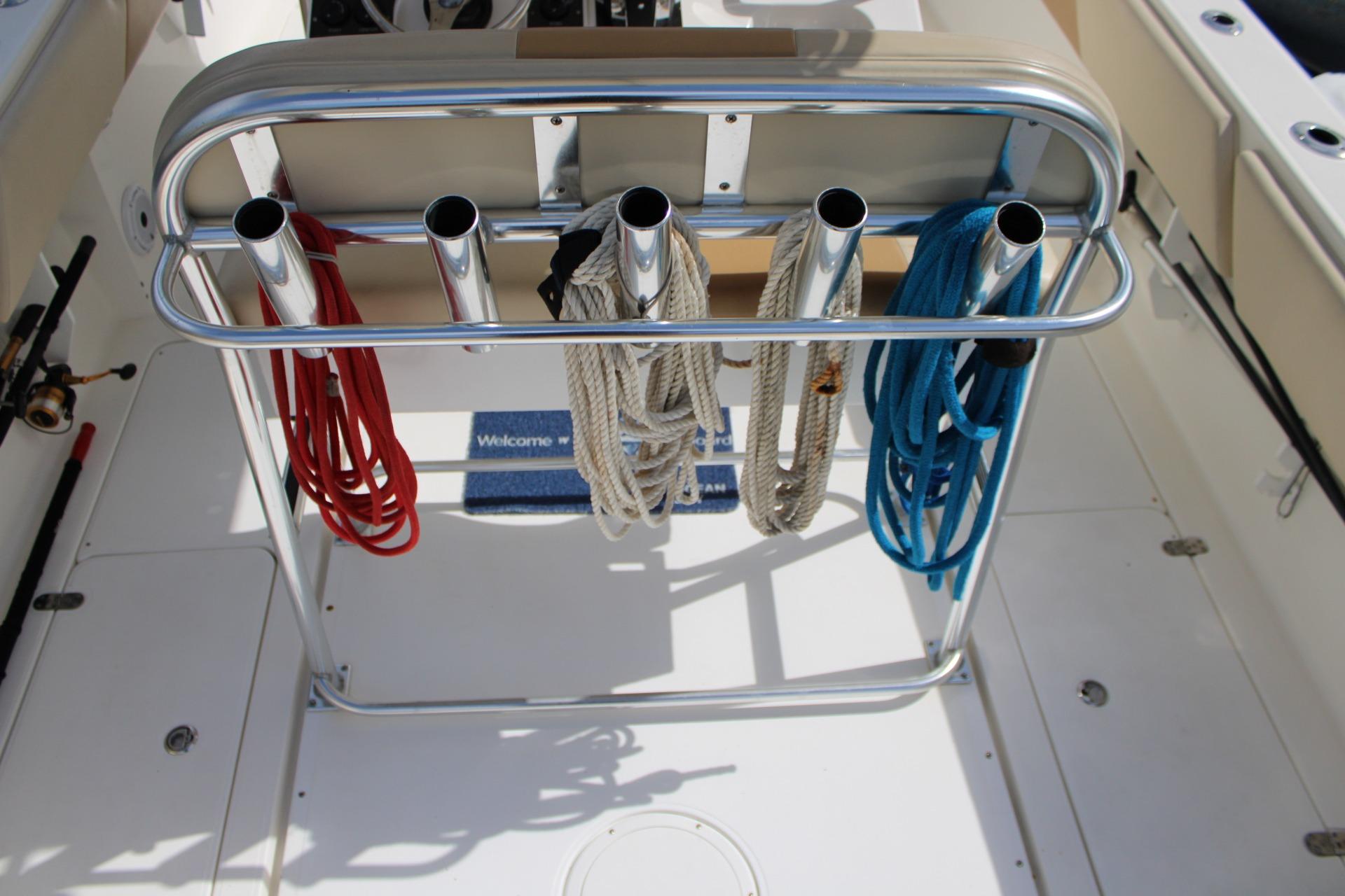 2007 Fountain 34 Center Console boat with rod holders and colorful ropes on deck.