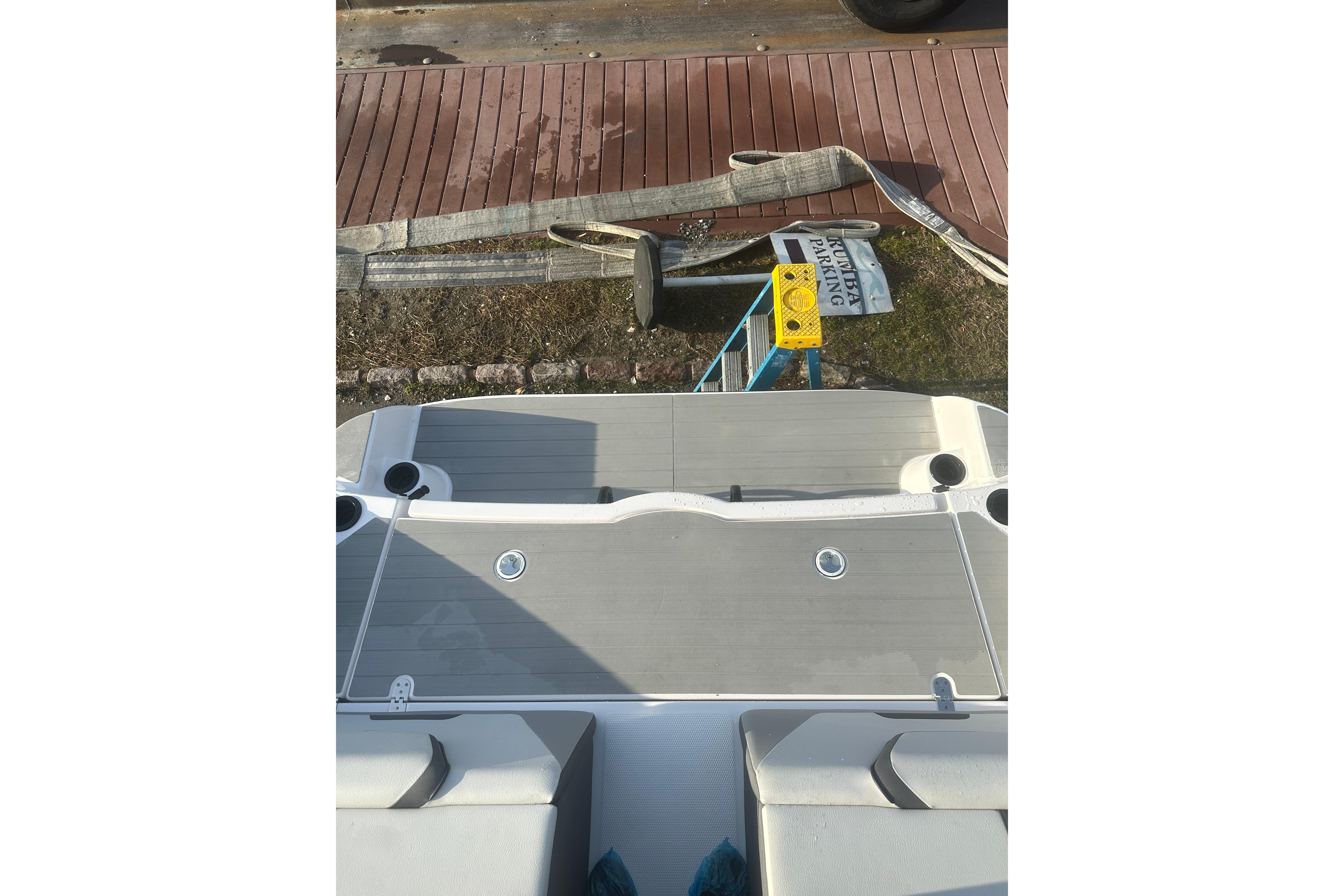 2025 Yamaha Boats AR220 swim platform with cup holders, dockside view.