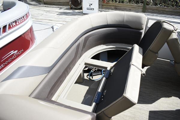 2023 Bennington 22 SXCW boat with open storage compartment and seating.