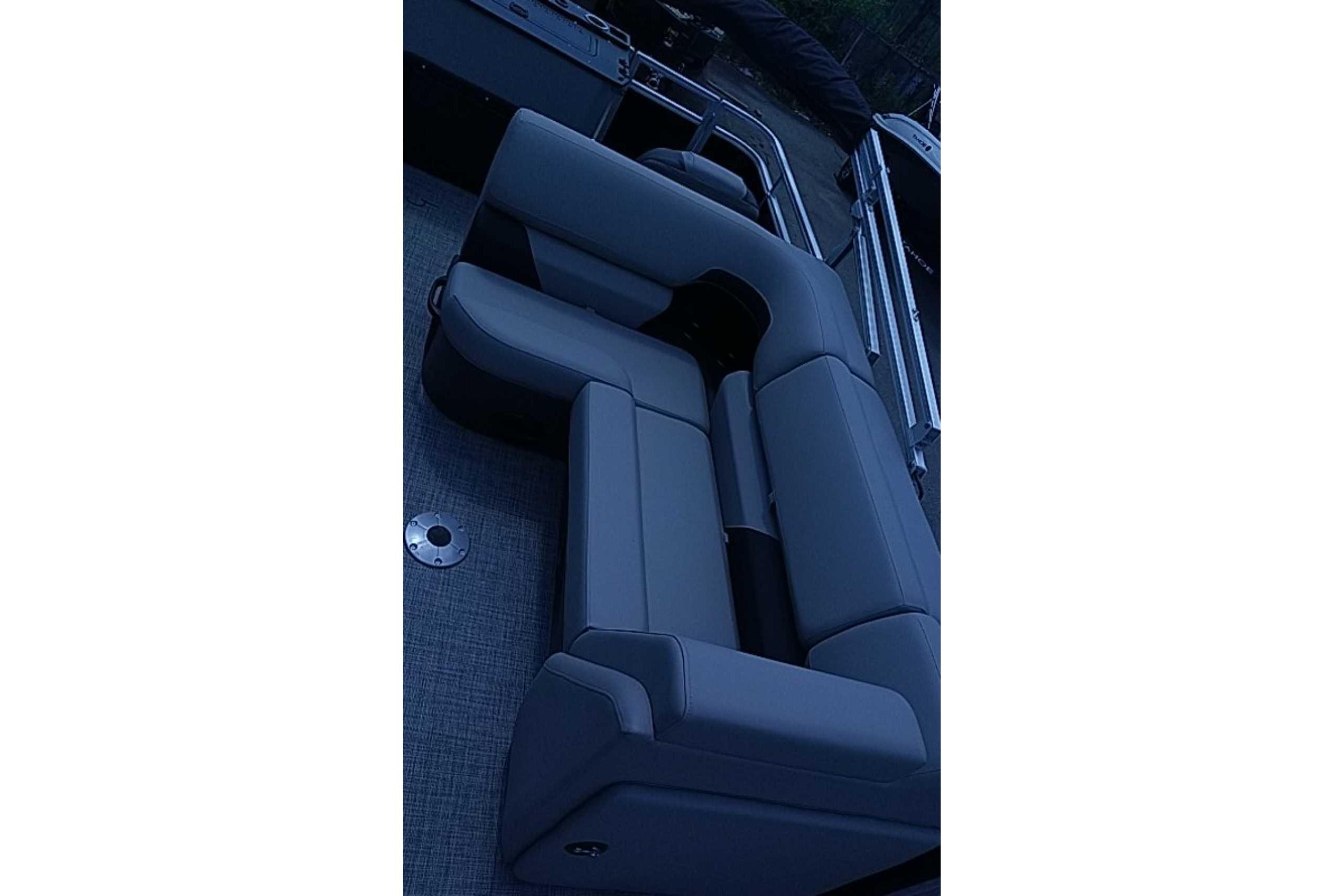 2026 Sun Tracker SportFish 22 DLX boat interior with gray seating and sleek design.