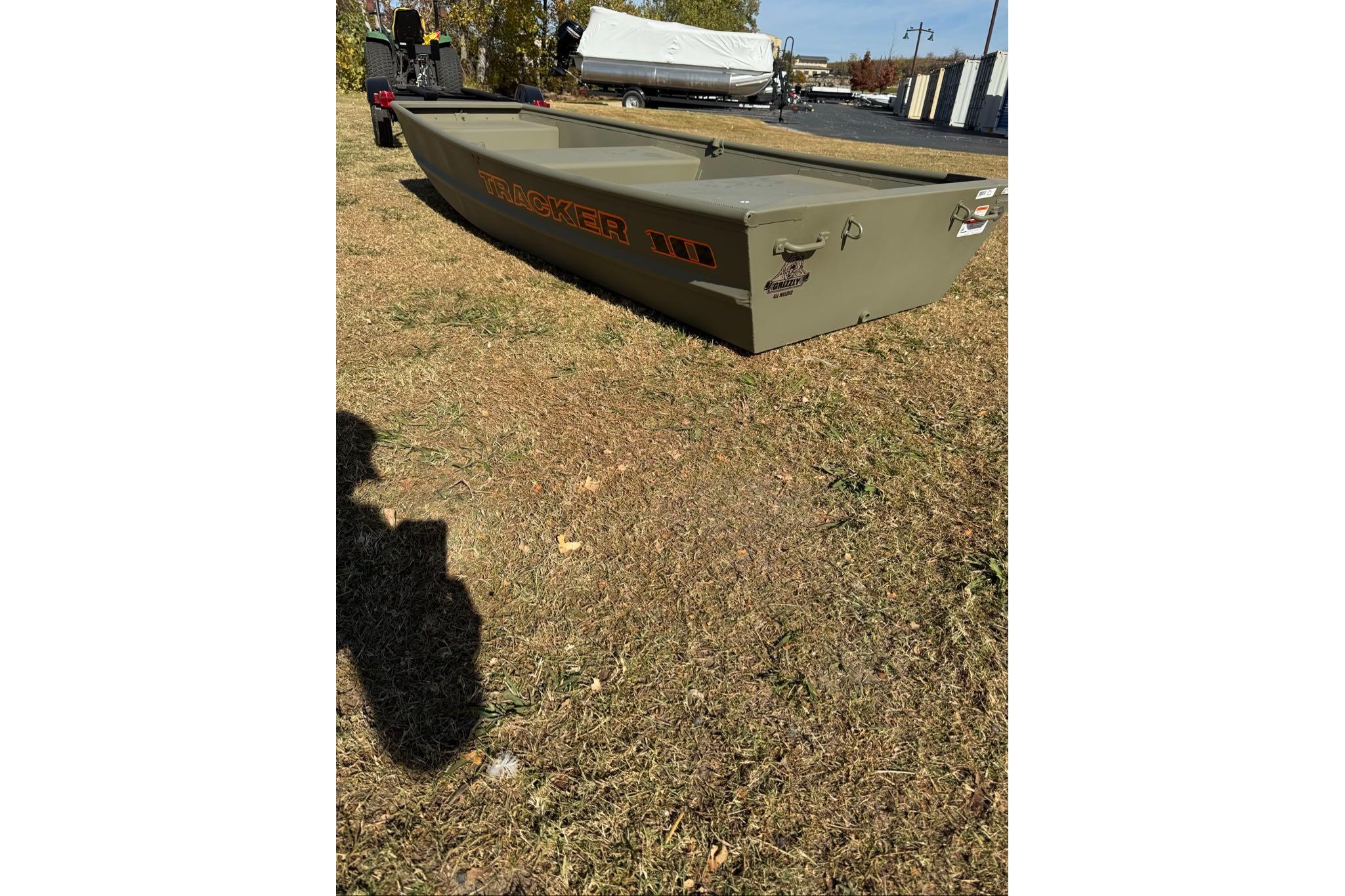 2026 Tracker Grizzly 10 Jon boat on grass, showcasing its sturdy design.