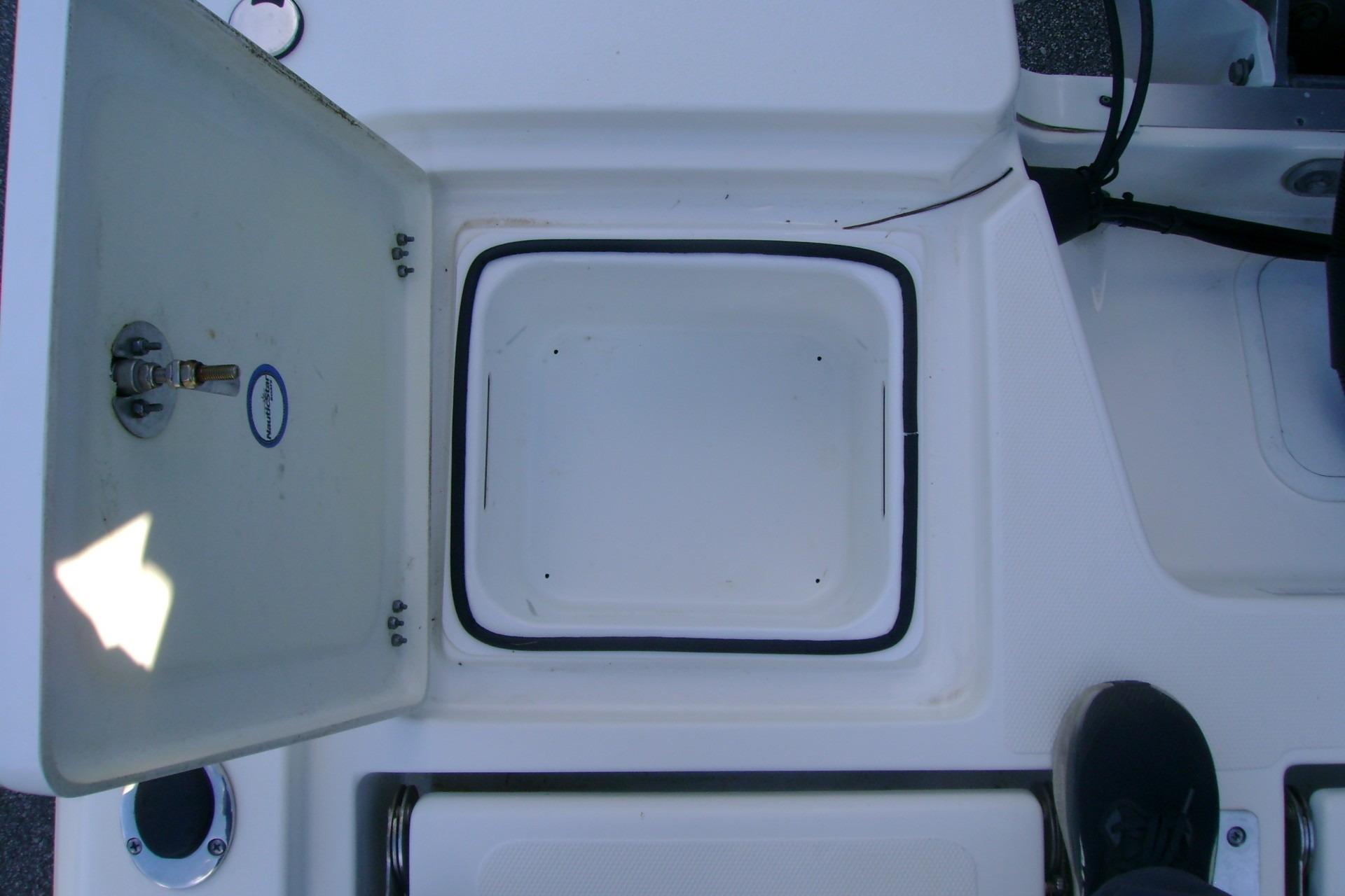 Open storage compartment on 2022 NauticStar 227 XTS boat deck.