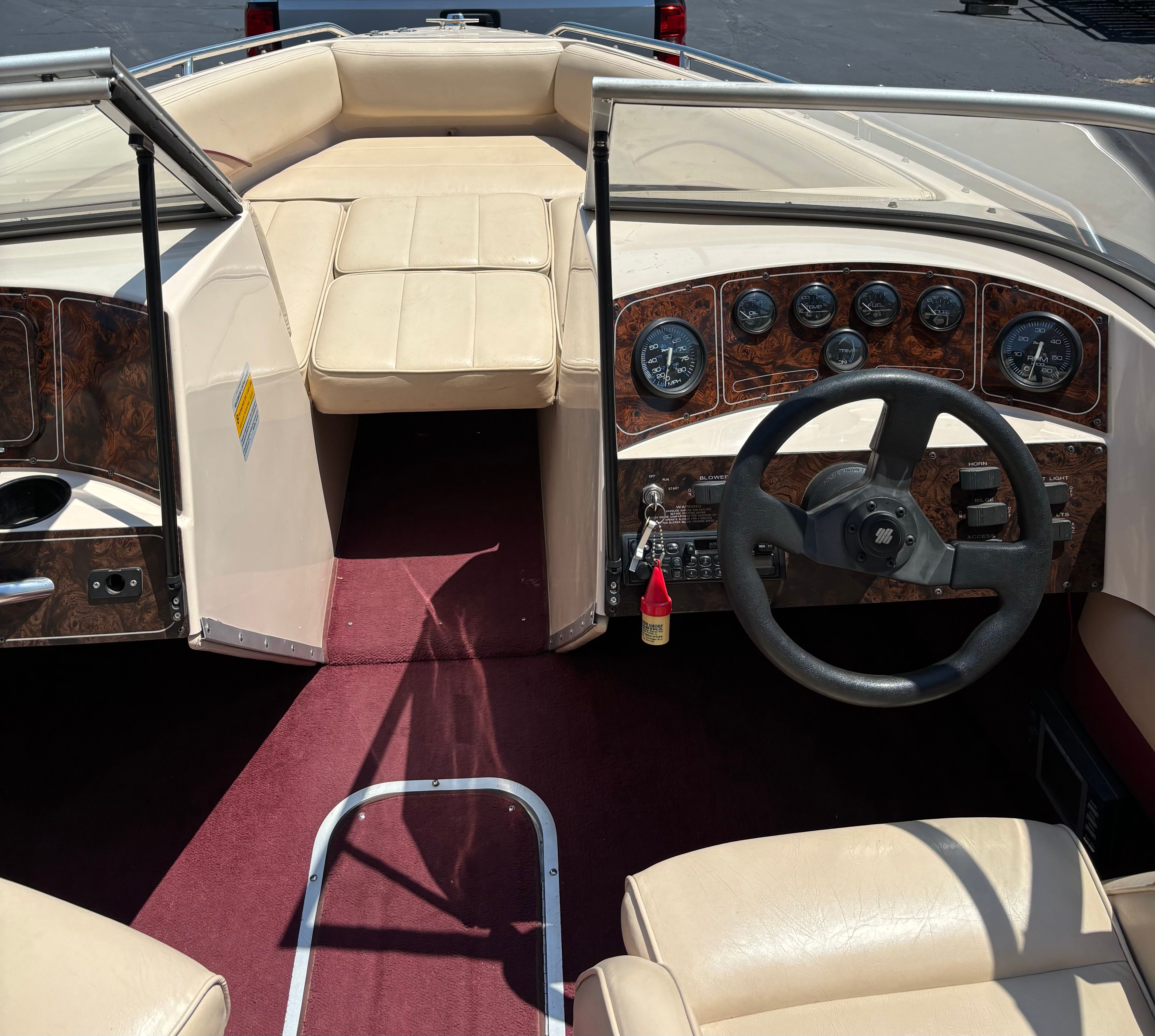 Interior of a 1996 Conquest 2100 boat with steering wheel and dashboard.