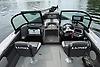 2023 Lund 1975 Tyee boat interior with modern controls and seating on a calm lake.