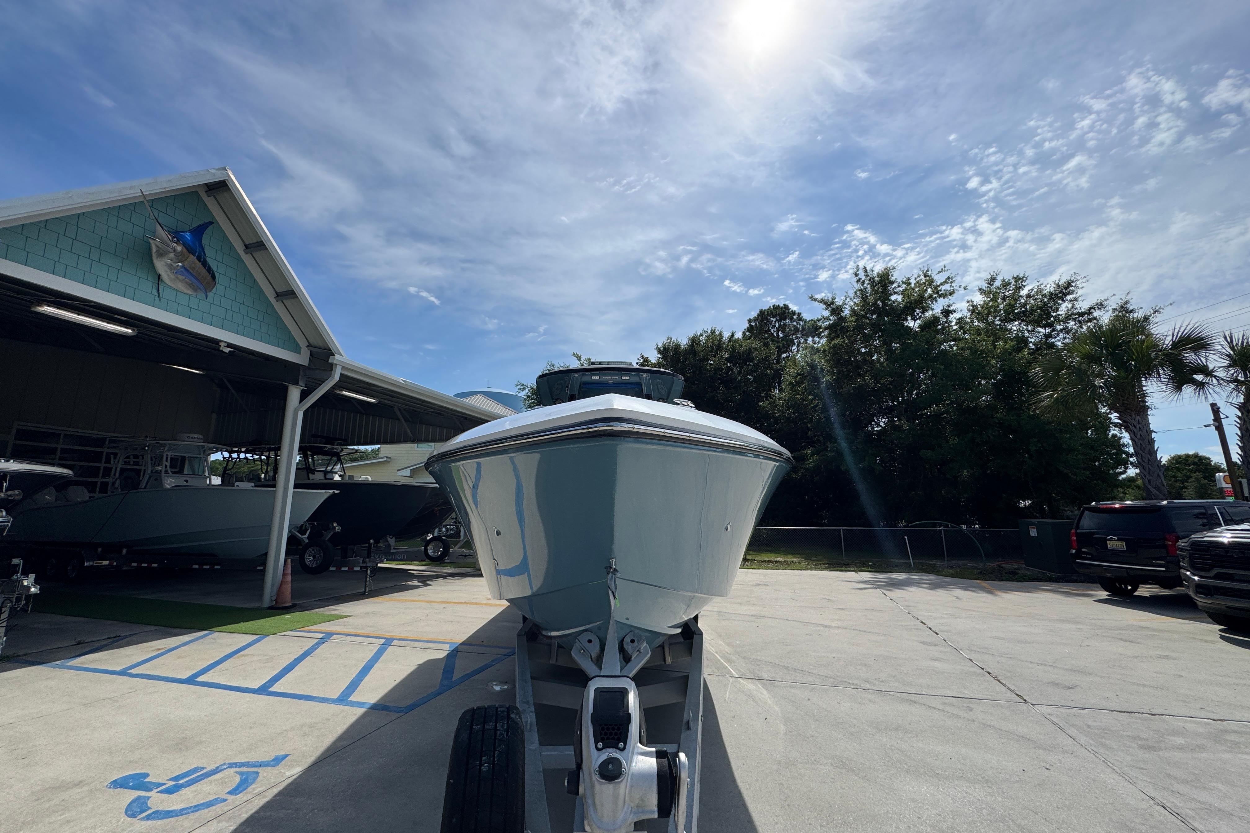 2023 Fountain 34 Tournament Edition boat on trailer under sunny sky.