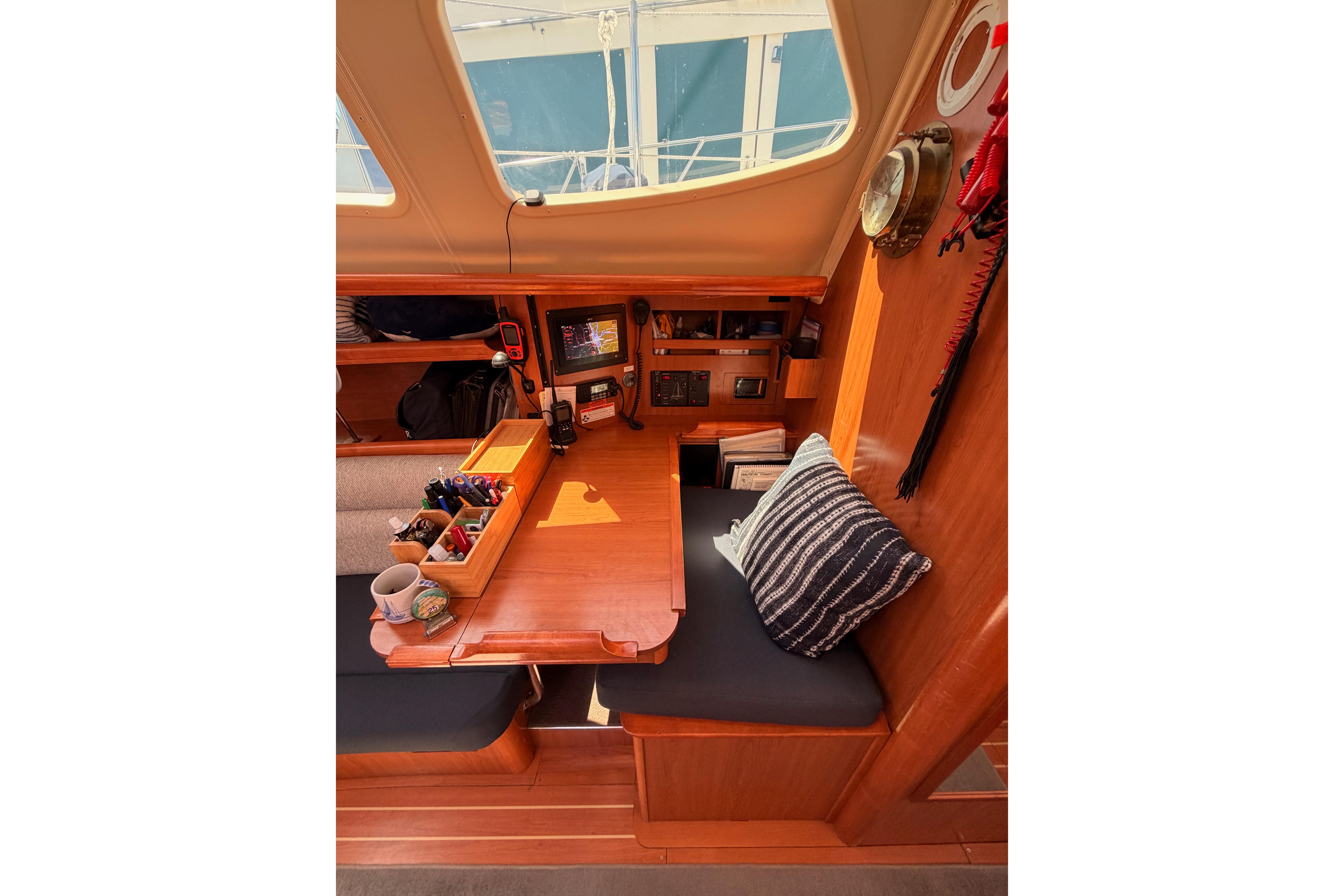 Interior of 2008 Hunter 45 Deck Salon with navigation station and cozy seating area.