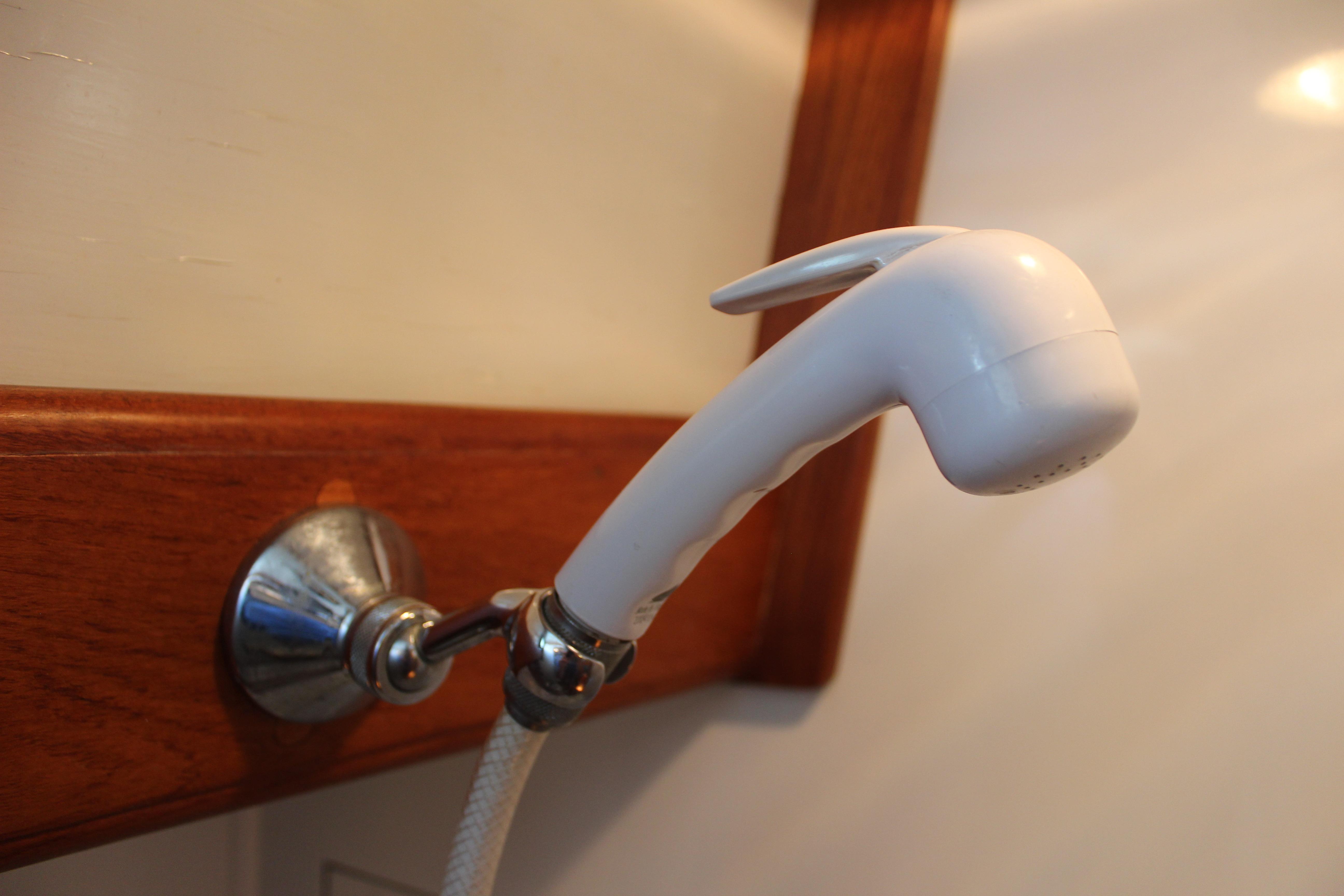 White shower head in a 1981 Kelly Peterson 46 yacht bathroom.