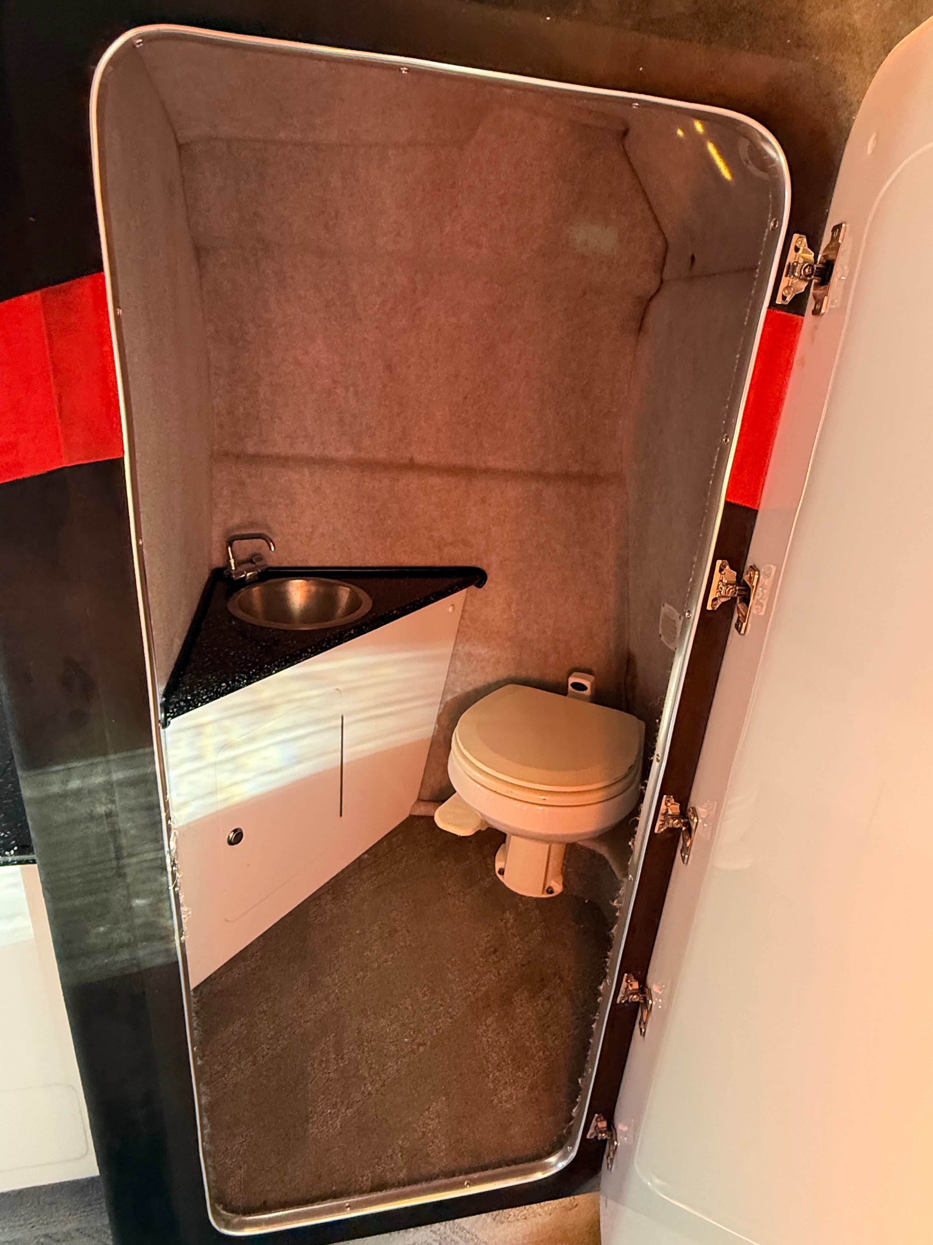 Interior of a 2009 Hallett 400T with toilet and sink.