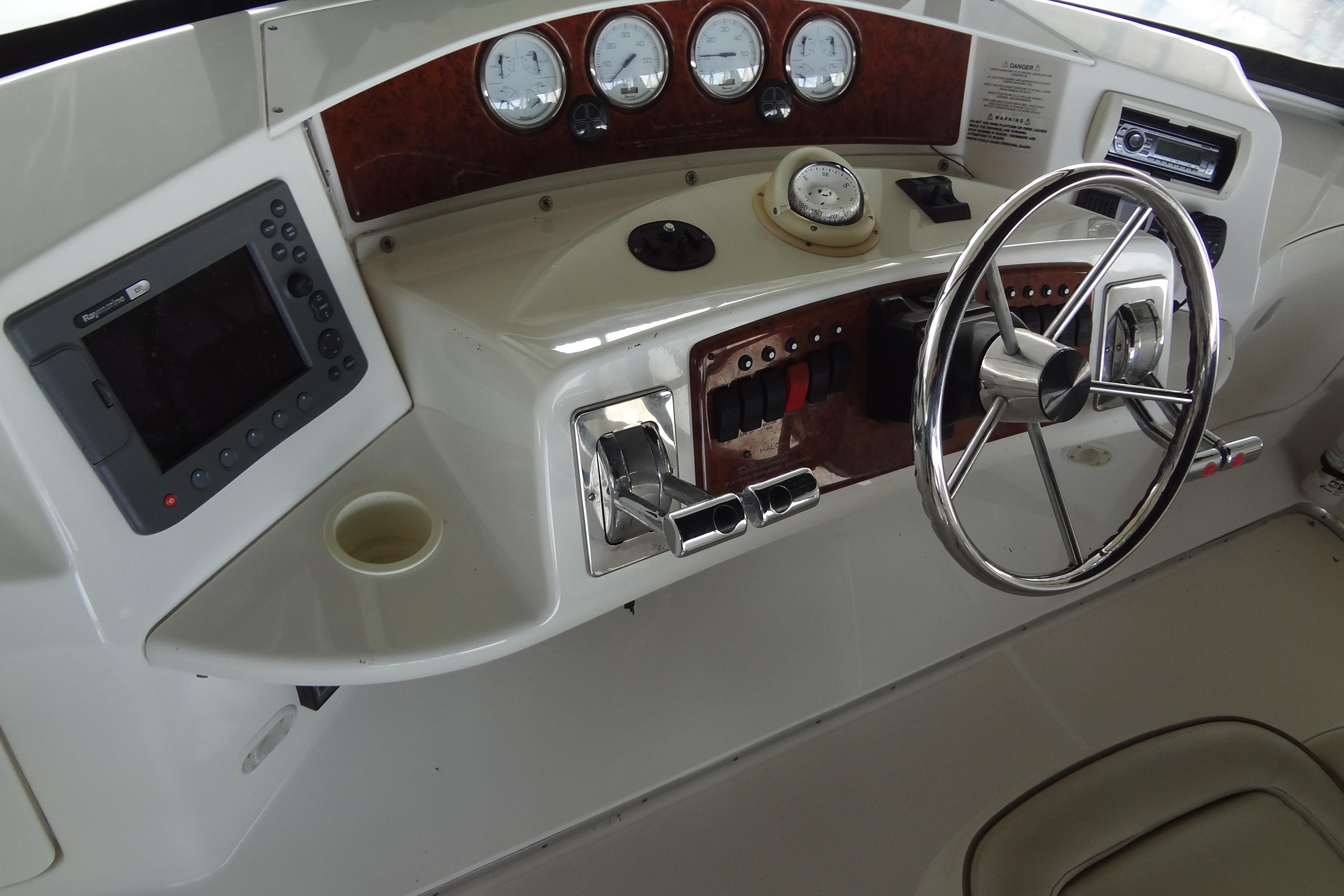 Control panel of a 2005 Silverton 34 Convertible boat with steering wheel and gauges.