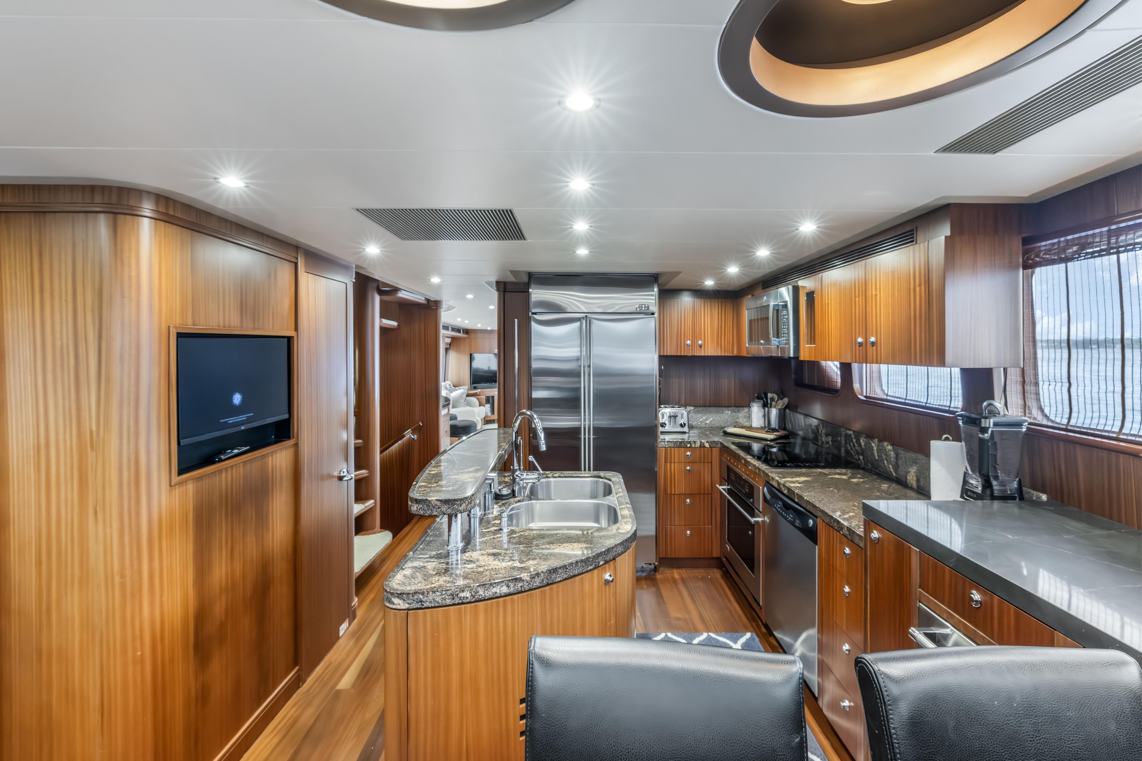 Luxurious 2012 Cheoy Lee 84 Bravo yacht interior with modern kitchen and elegant wood finishes.