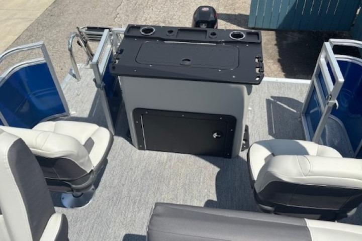 2026 Sun Tracker Fishin' Barge 20 DLX interior with seating and control console.