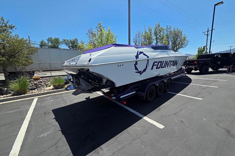 2004 Fountain 38 Lightning boat on trailer in parking lot, sunny day.