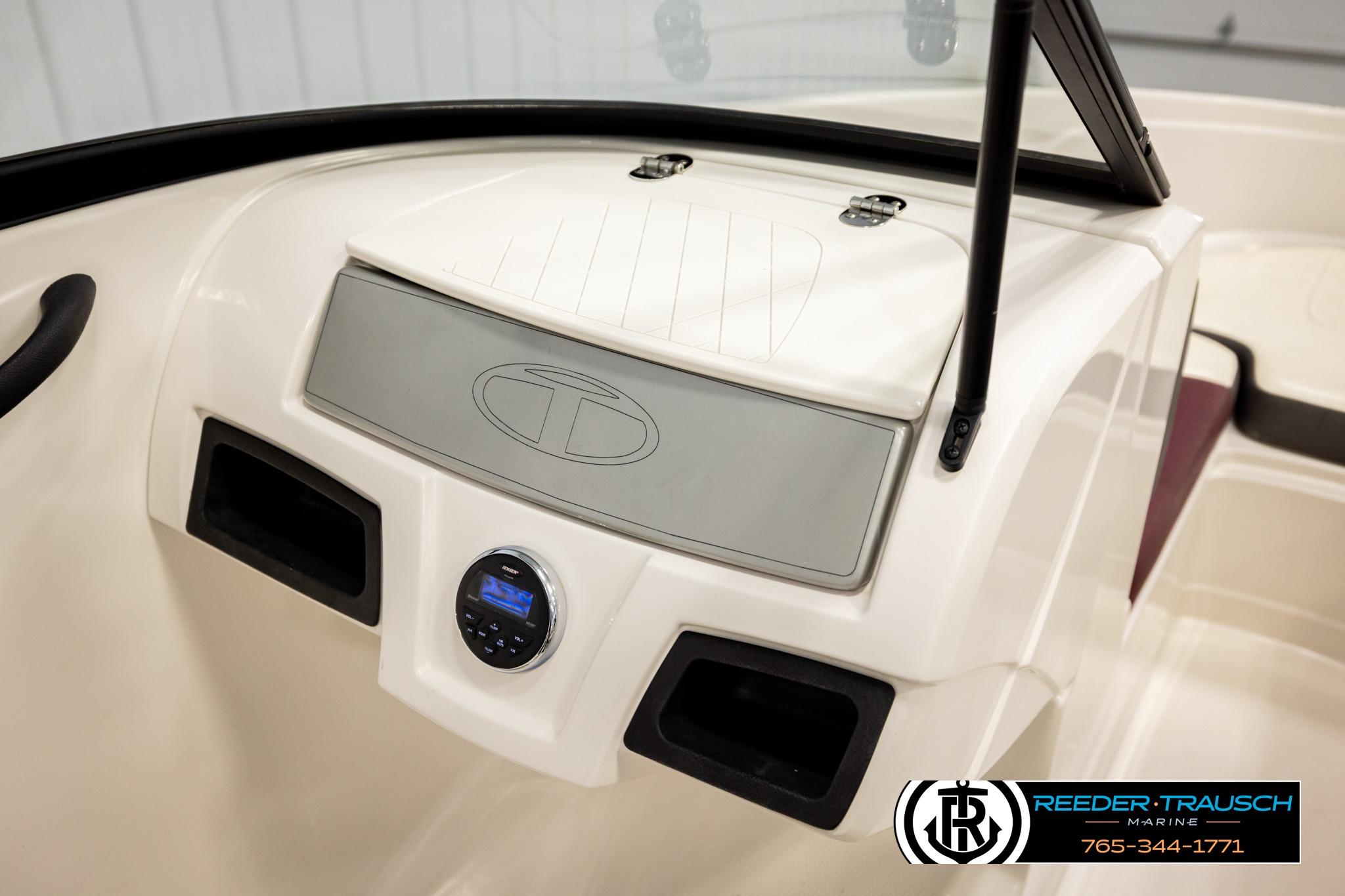 Dashboard of a 2016 Tahoe 450 TS boat with stereo system and logo.
