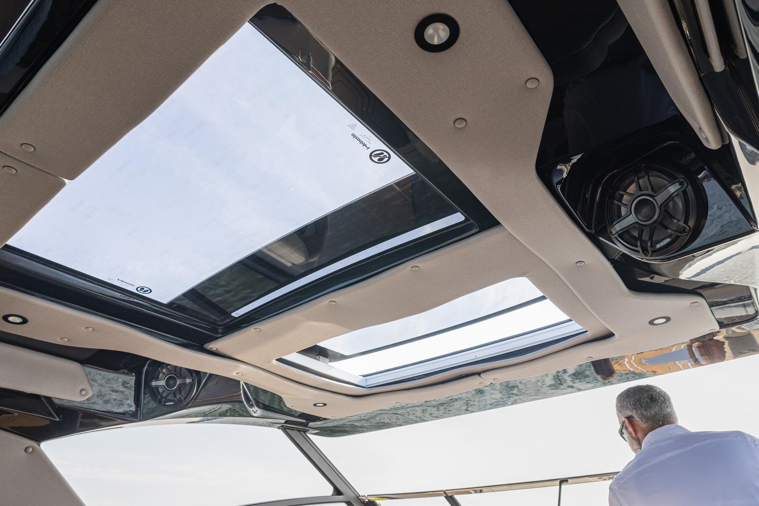 2026 Hurricane SunDeck 3200 OB boat interior with sunroof and speaker system.