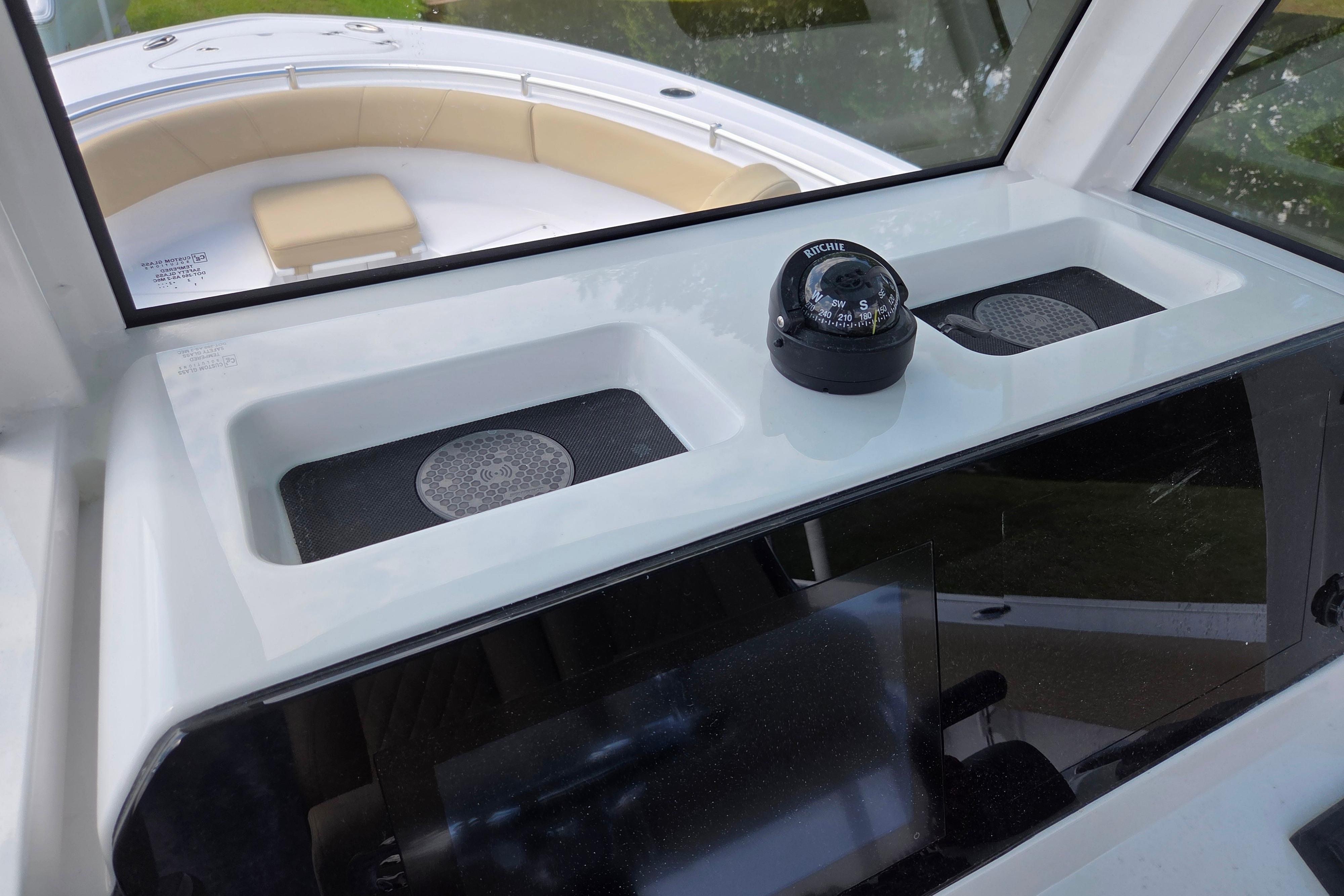 2026 Sportsman Open 232 Center Console boat interior with compass and seating area.