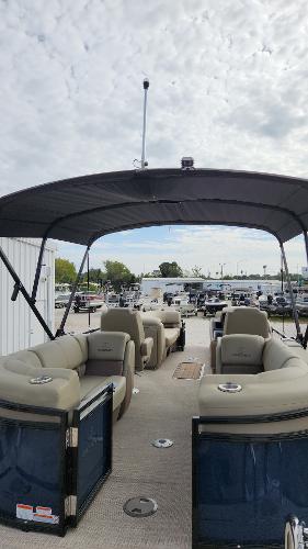 2024 Regency 230 LE3 pontoon boat with spacious seating and canopy.