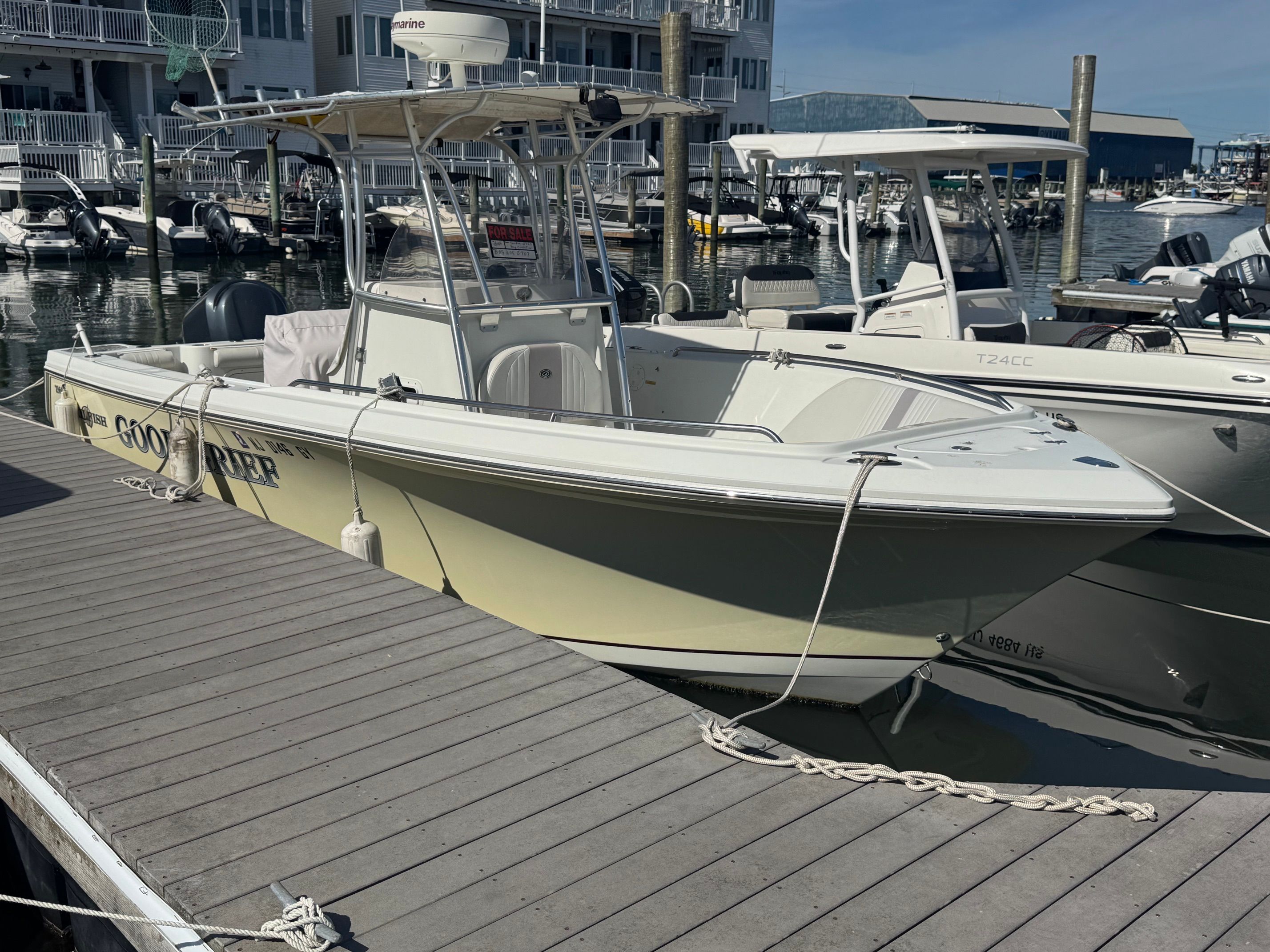 2006 Sailfish 2360 CC boat docked at marina.