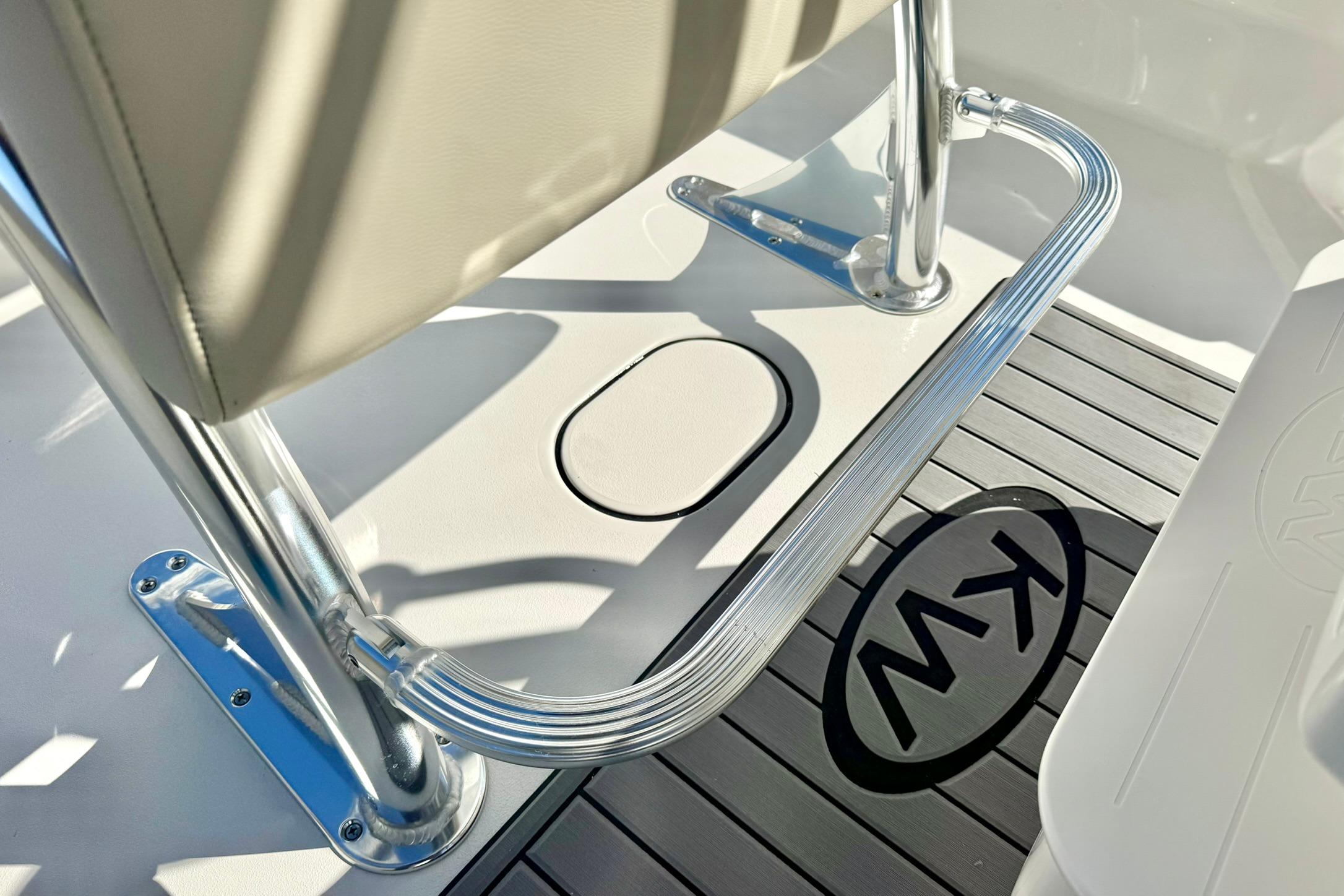 2026 Key West 189 FS boat interior with chrome railing and KW logo on deck.