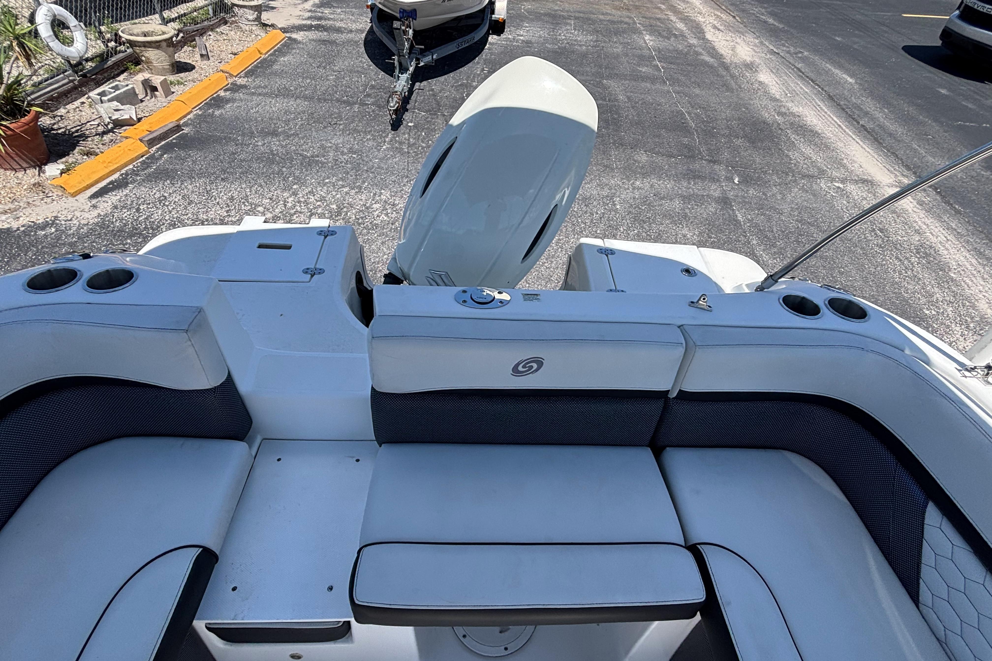 2019 Hurricane Sundeck Sport 218 OB boat interior with seating and outboard motor.