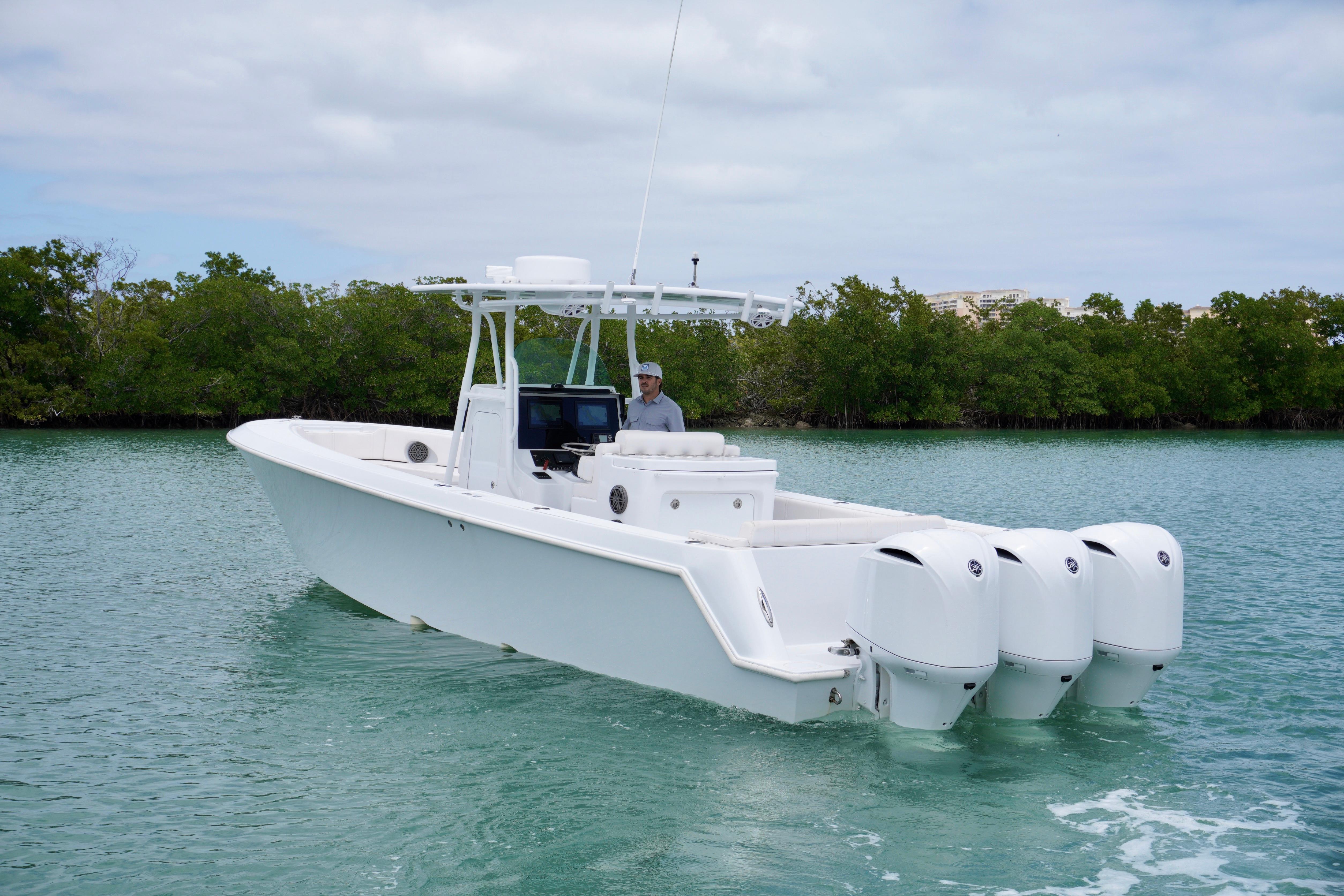 2013 Contender 35 LS boat with triple engines cruising on calm water.