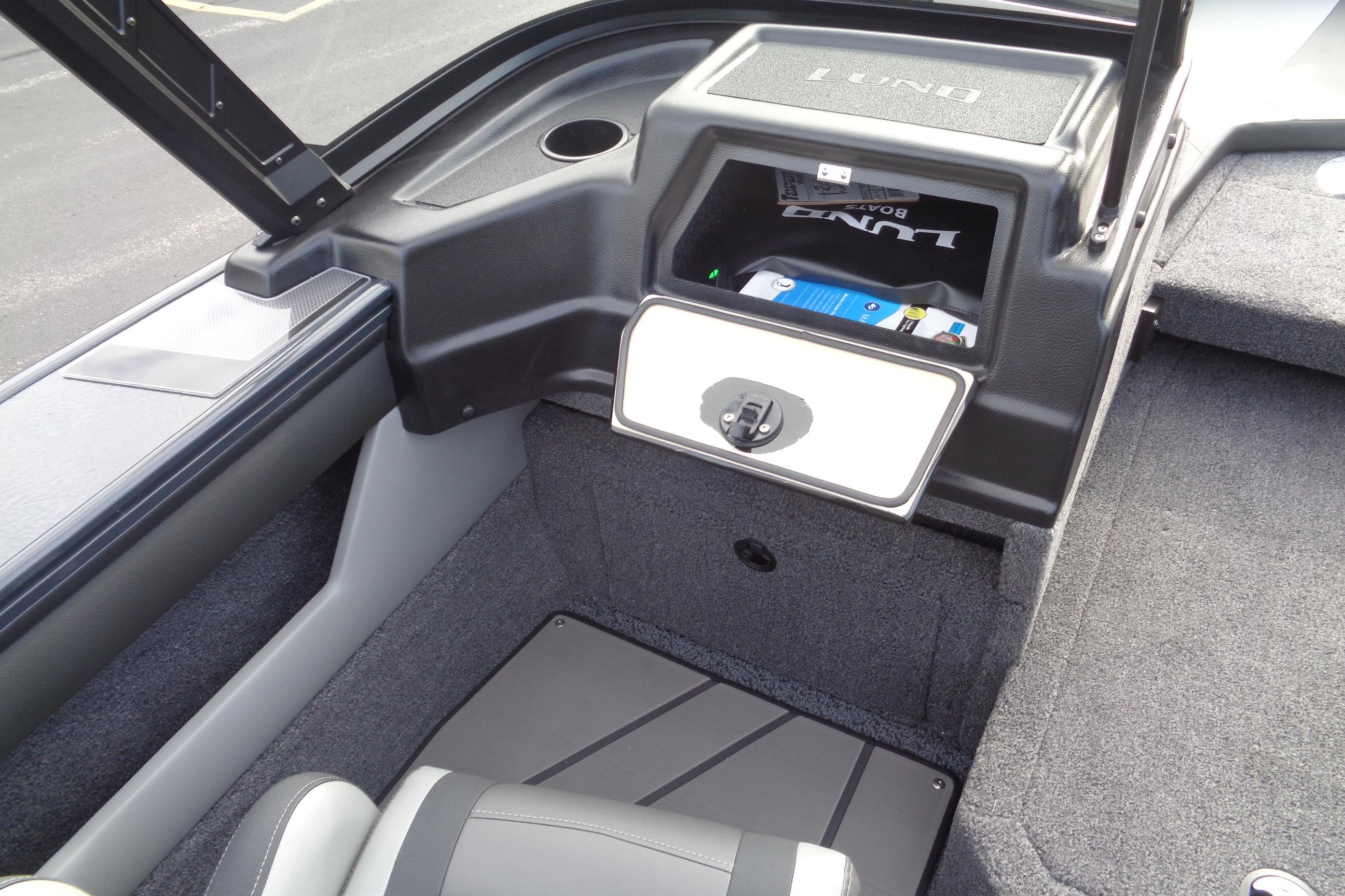 2026 Lund 1875 Crossover XS boat interior with storage compartment and seating.