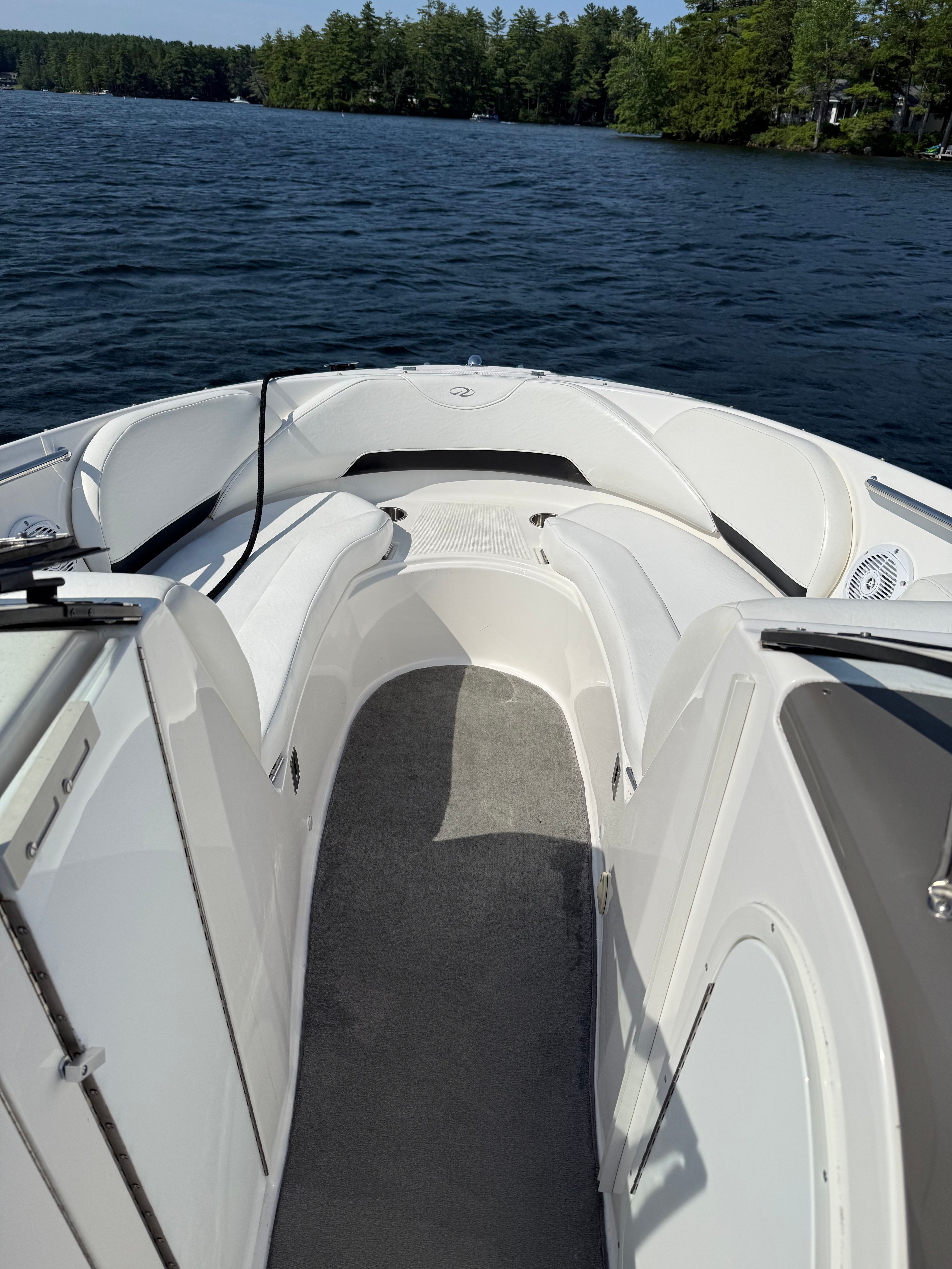 2007 Regal 2400 Bowrider boat interior with white seating on a lake.
