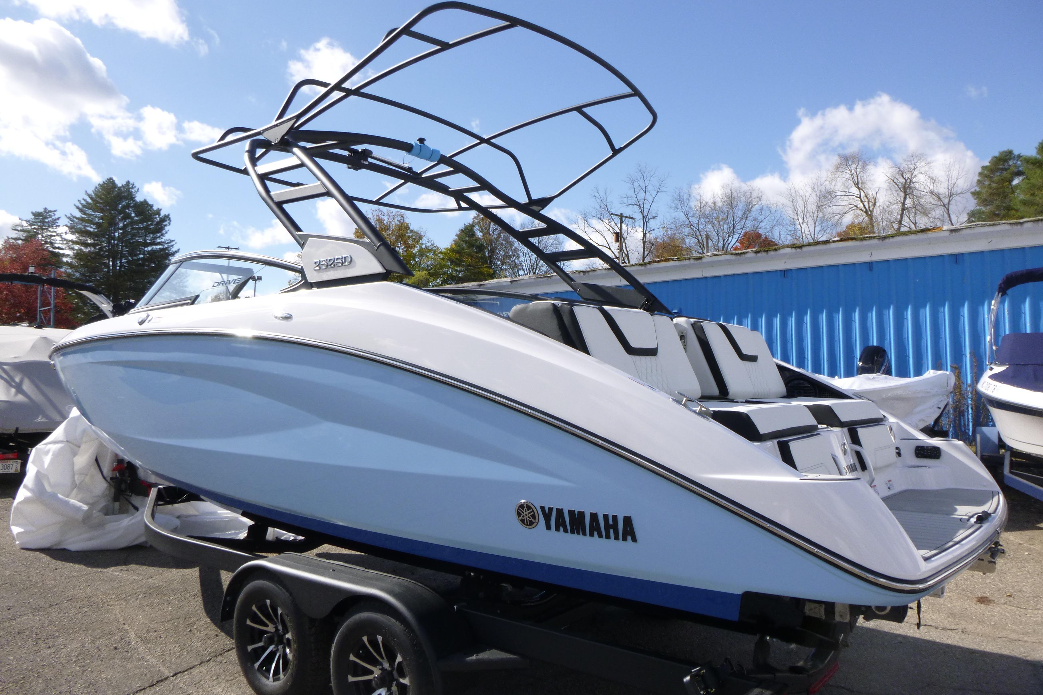 2026 Yamaha Boats 252SD on trailer, sleek design, blue and white exterior, sunny day.