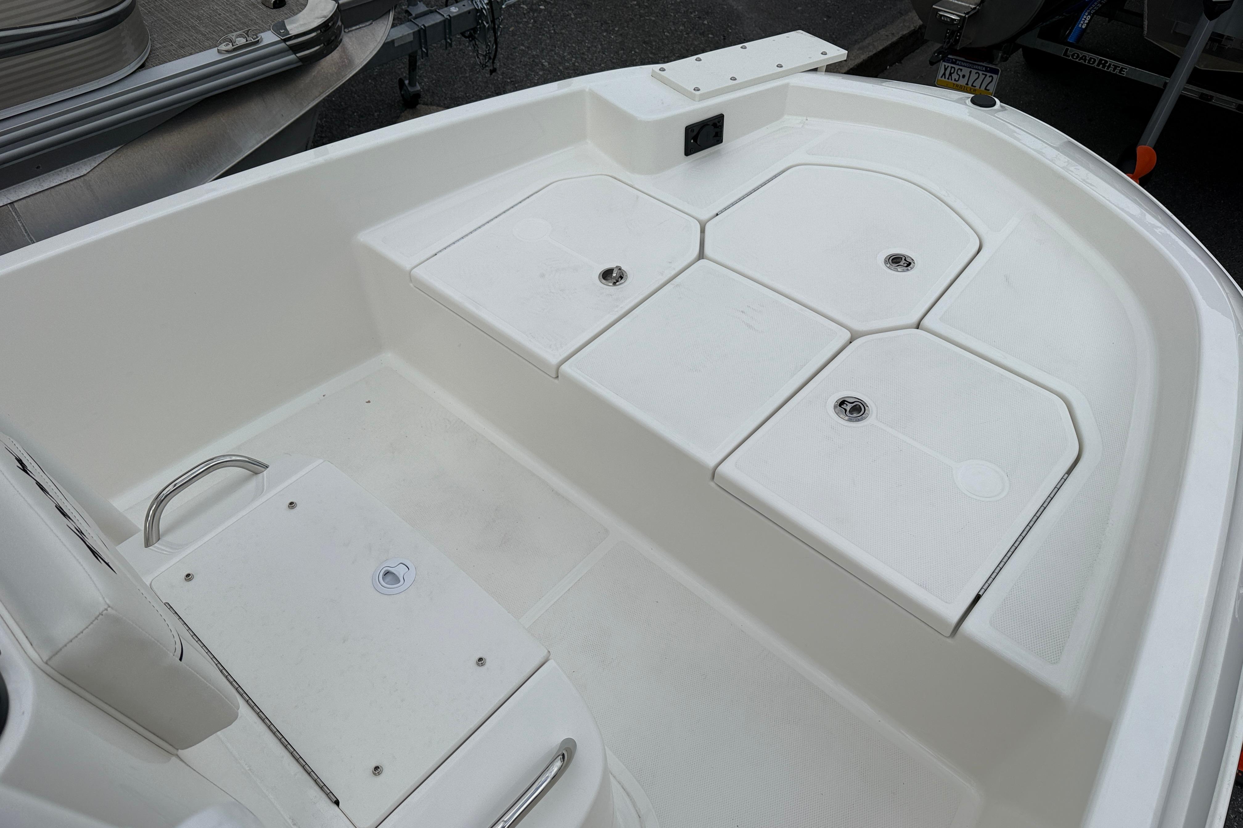 2026 Bayliner Trophy T18 boat deck with storage compartments and seating.