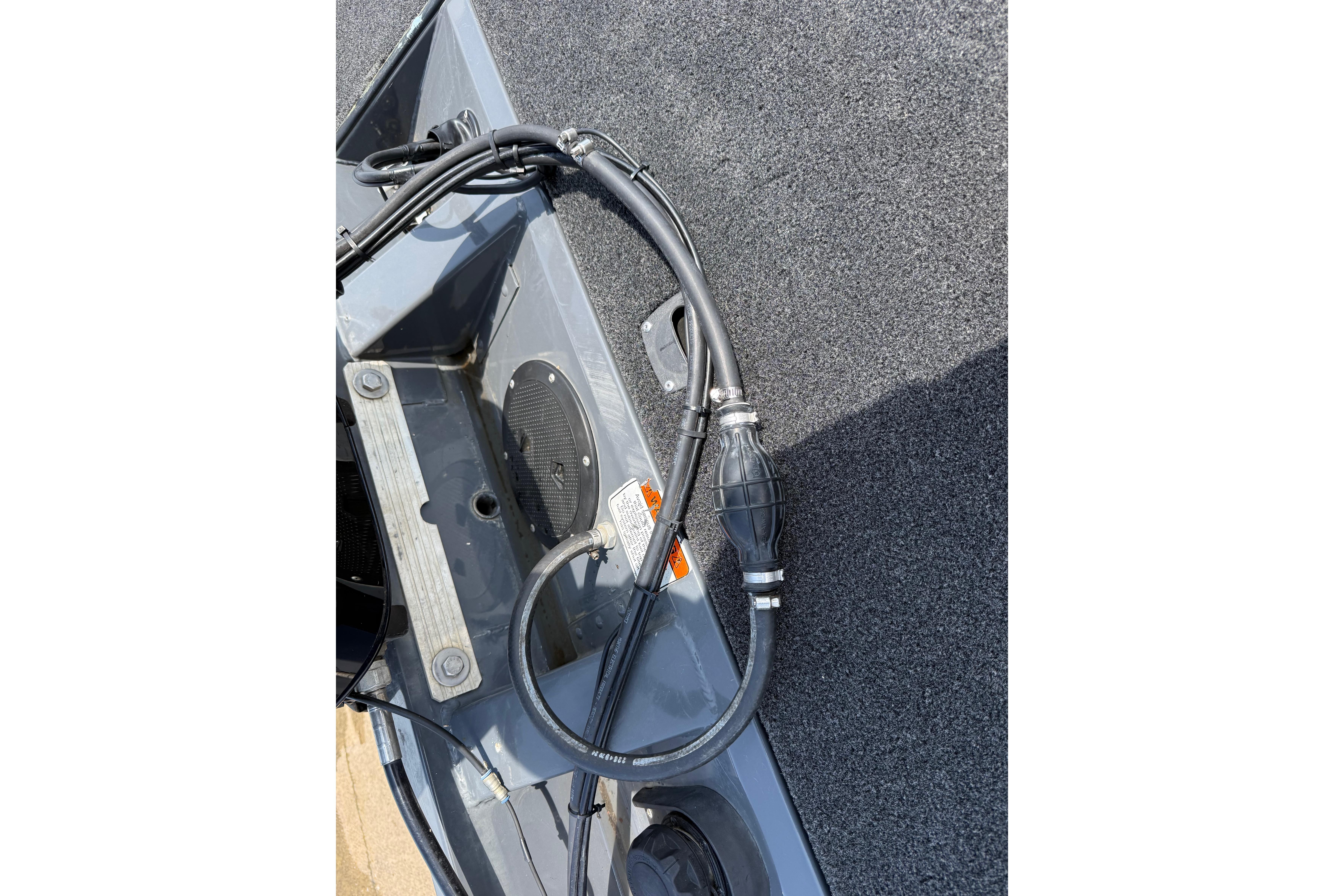 2015 Tracker Pro Team 190 TX boat deck with fuel line and fittings.