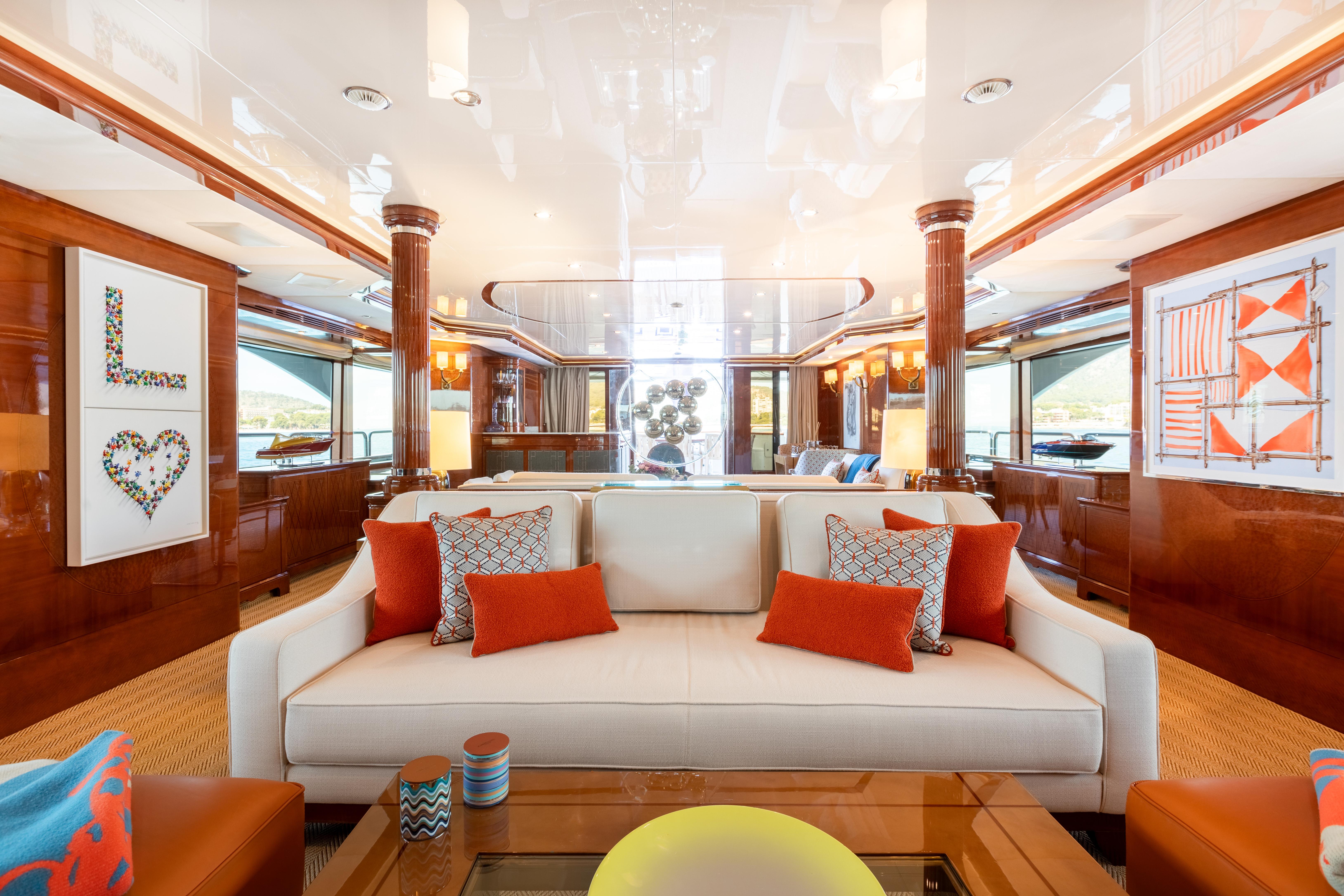 Luxurious interior of 2013 Benetti 44 yacht with elegant decor and vibrant cushions.