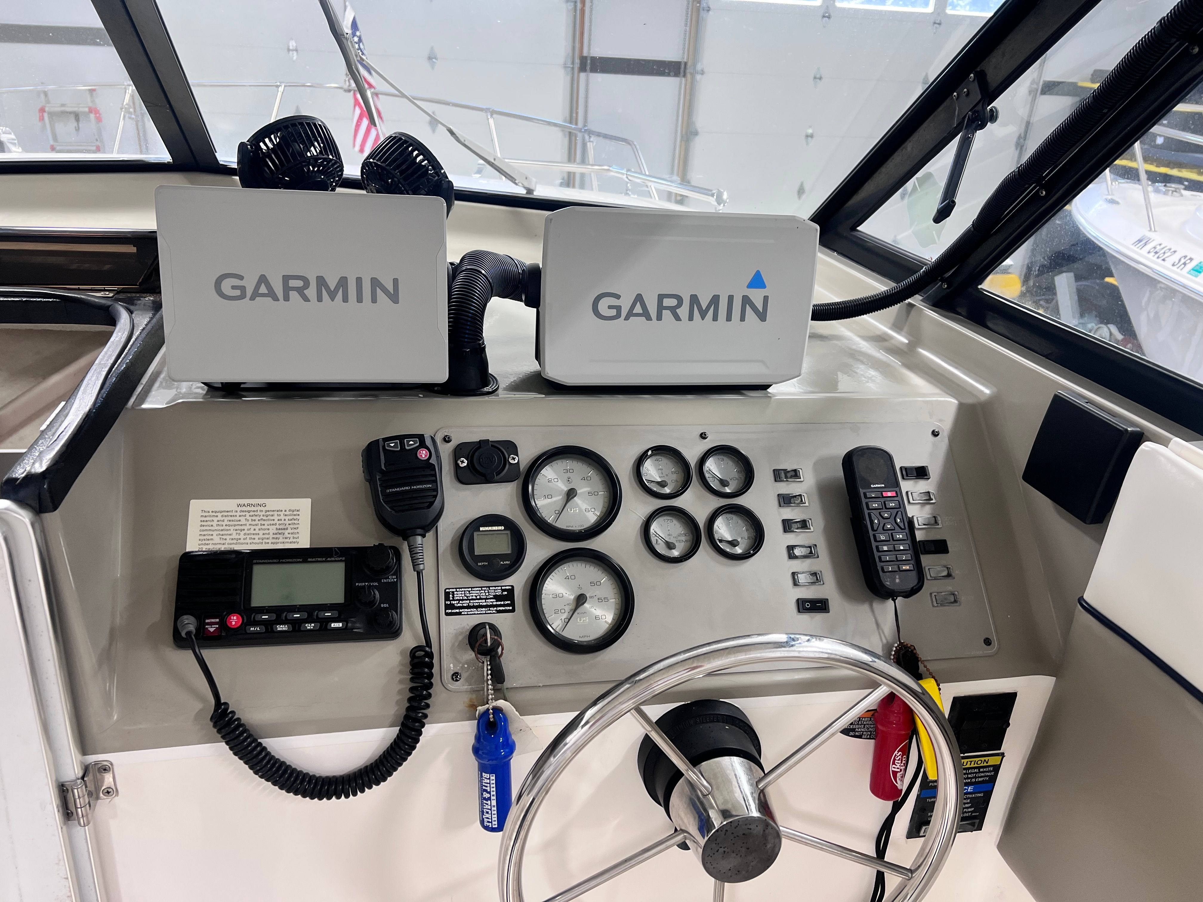 Dashboard of a 1997 Bayliner 2452 with Garmin devices.