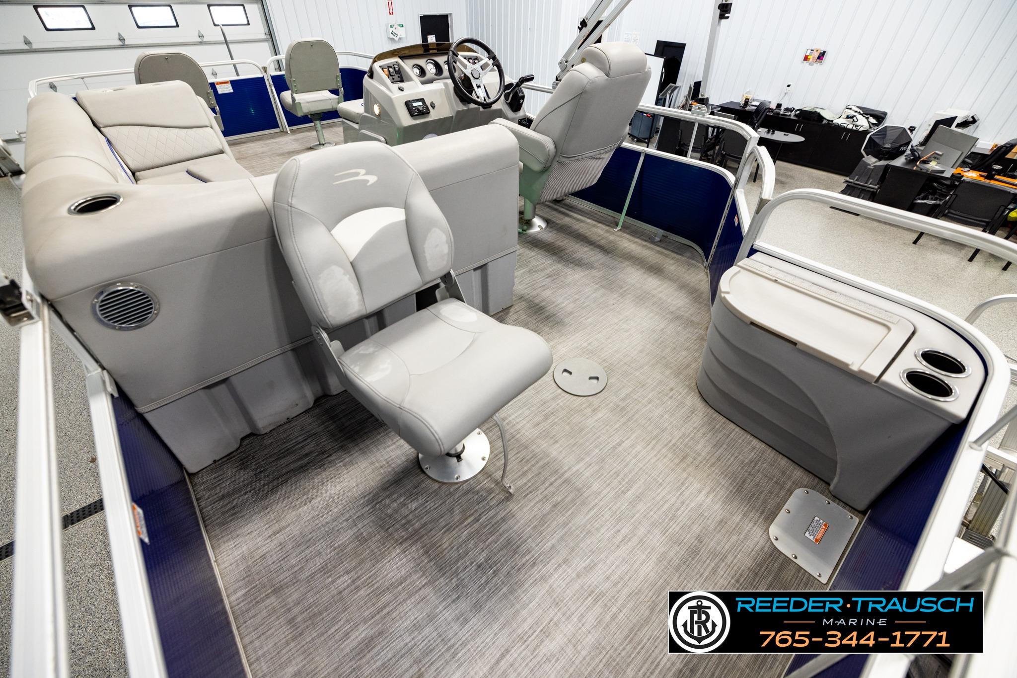 Interior of a 2021 Bennington 20 SV pontoon boat with gray seating and steering console.