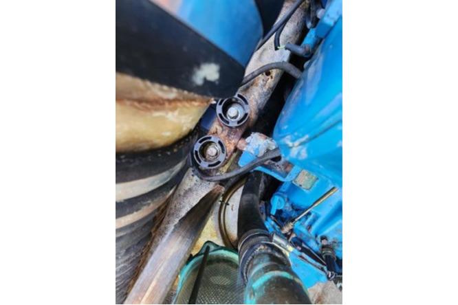 Engine components of a 1985 Wasque Down East Cruiser, featuring hoses and metal fittings.