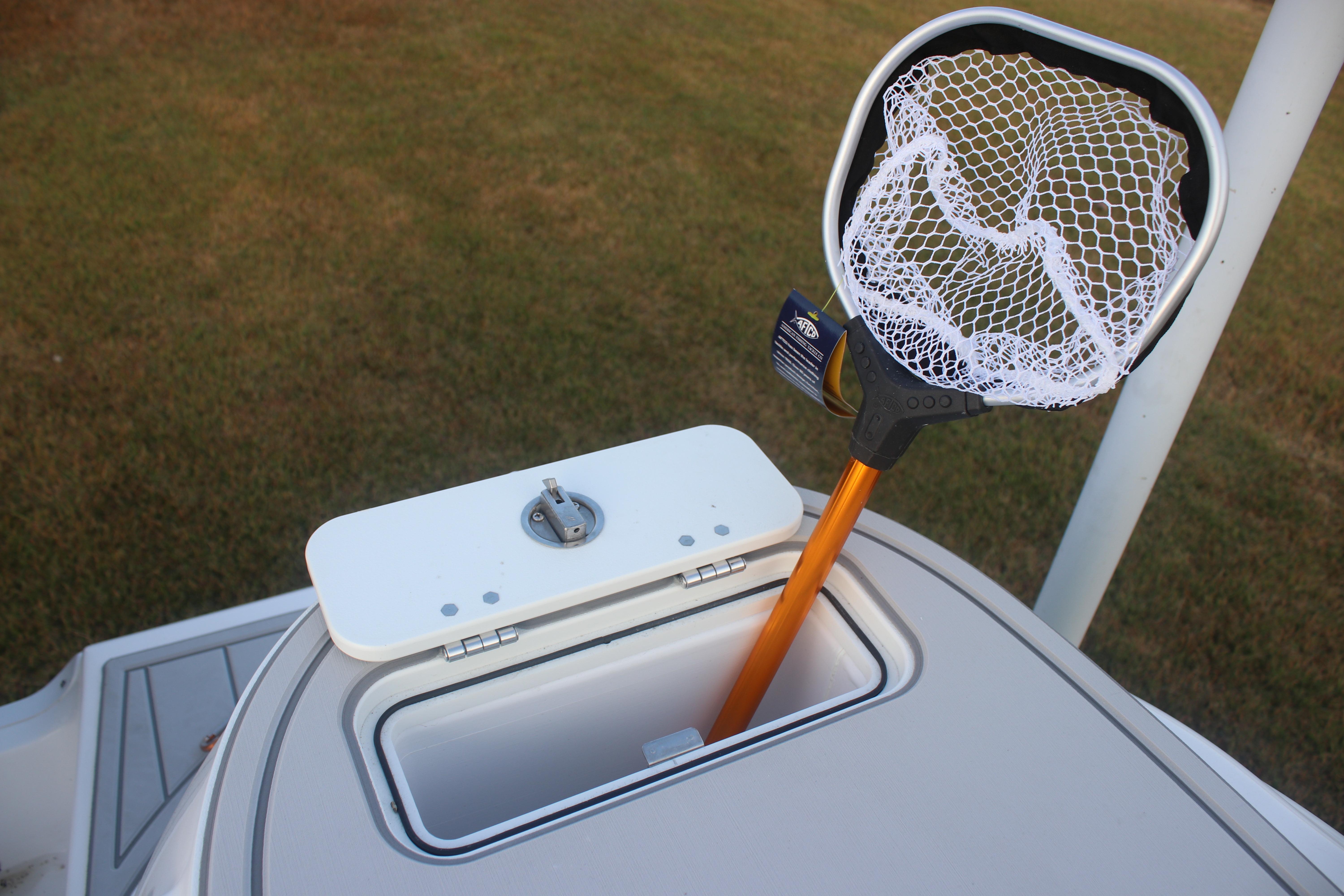 2026 Sea Fox 228 Commander boat with a fishing net in storage compartment.