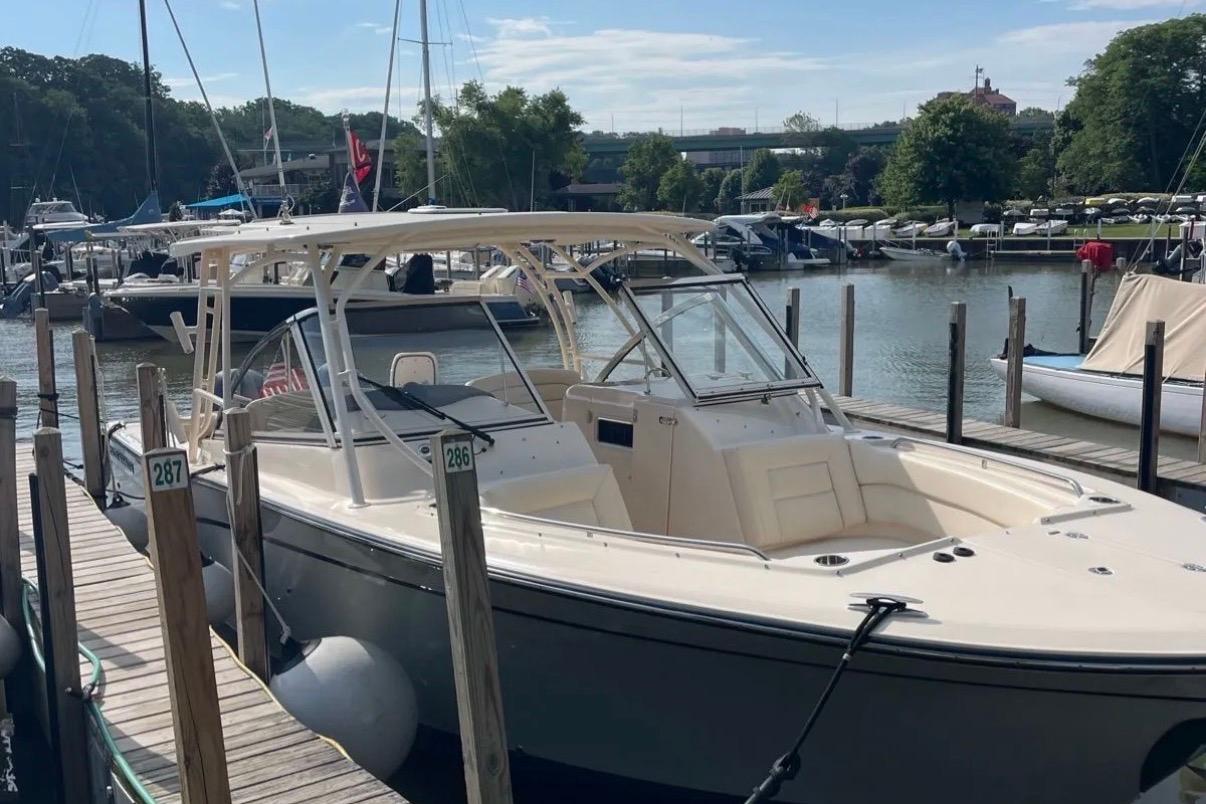 2019 Grady-White Freedom 307 boat docked at a marina, surrounded by other vessels.