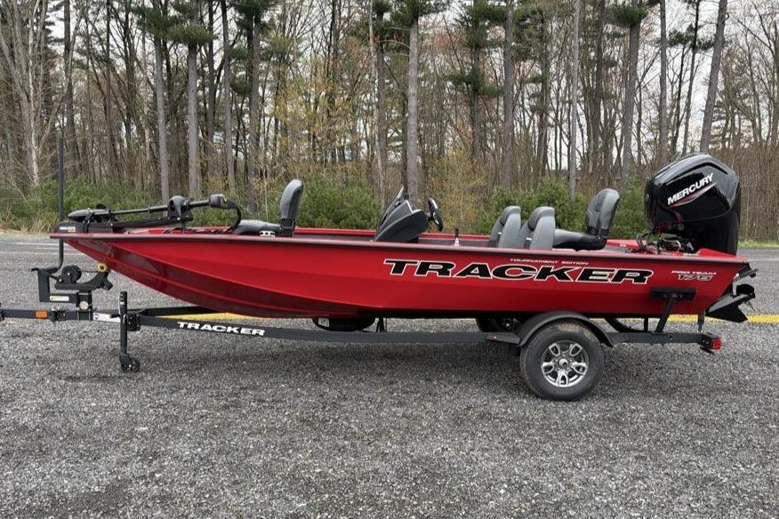 2026 Tracker Pro Team 175 boat on trailer, red color, parked outdoors.