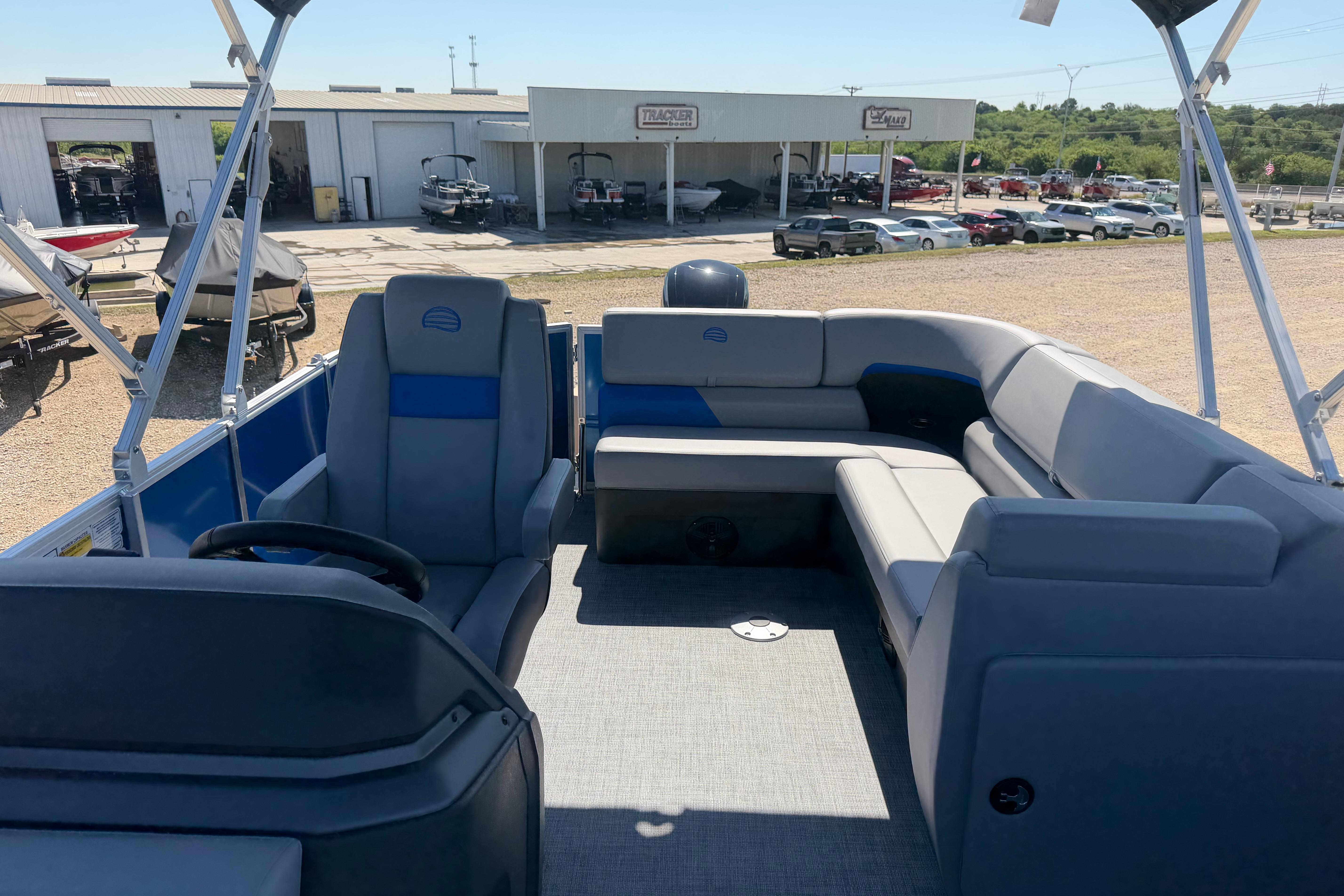 2026 Sun Tracker Party Barge 20 DLX interior with spacious seating and steering console.